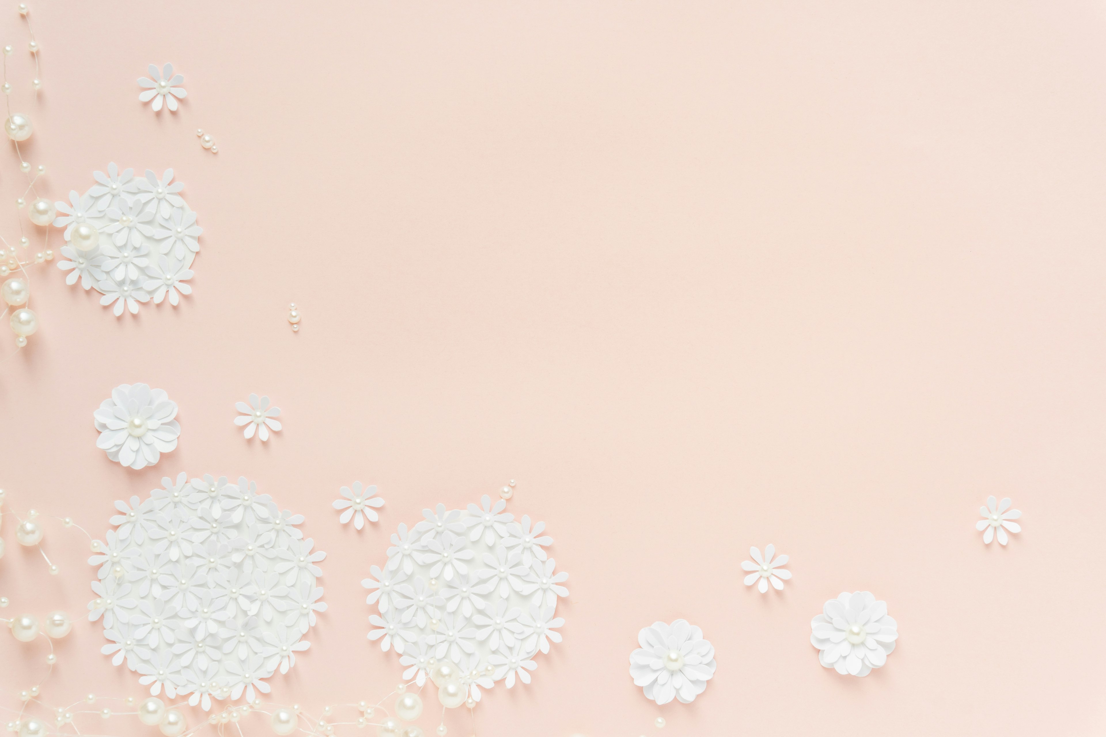 White powder and grains arranged randomly on a soft pink background