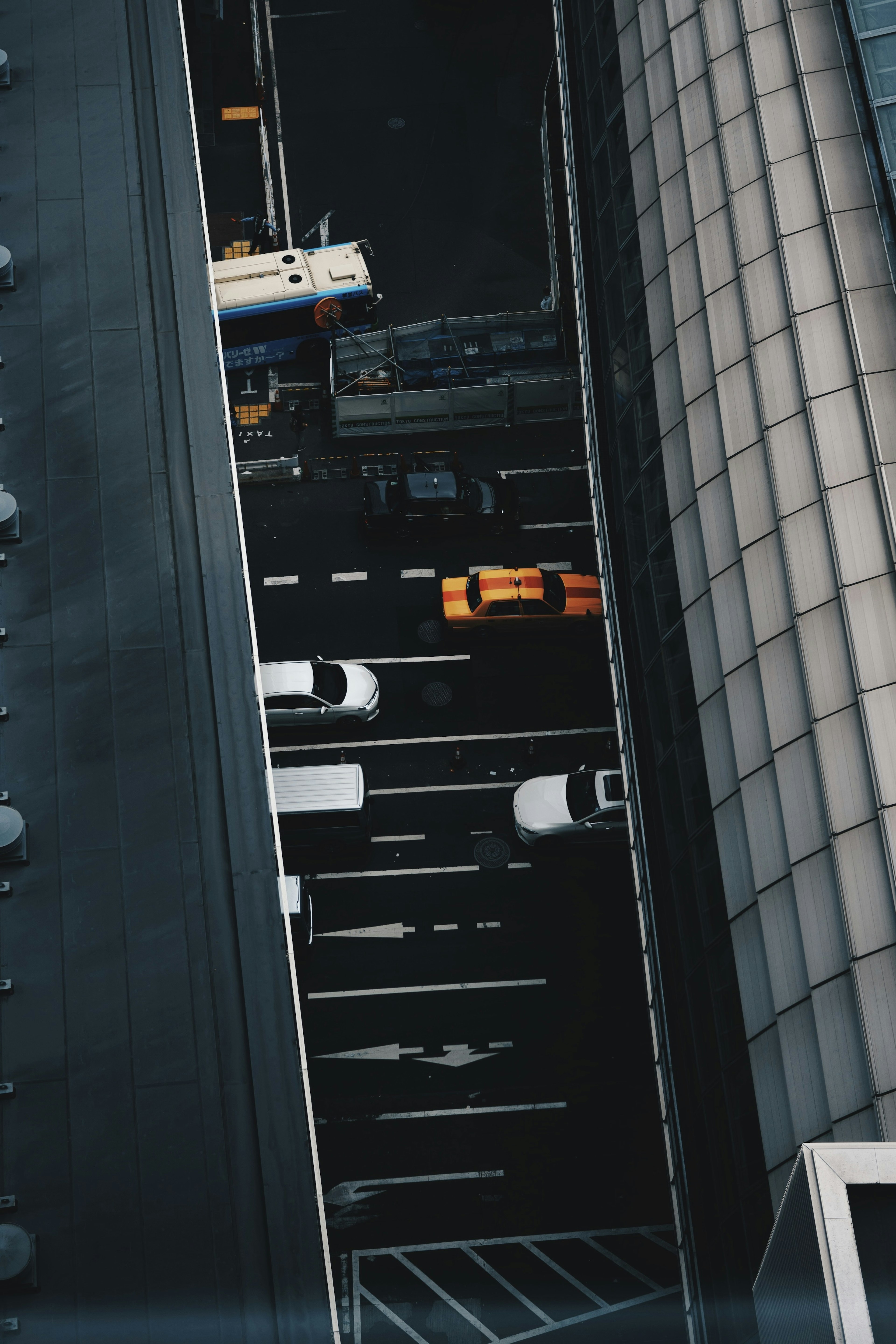 Aerial view of urban intersection with yellow and white taxis on the streets