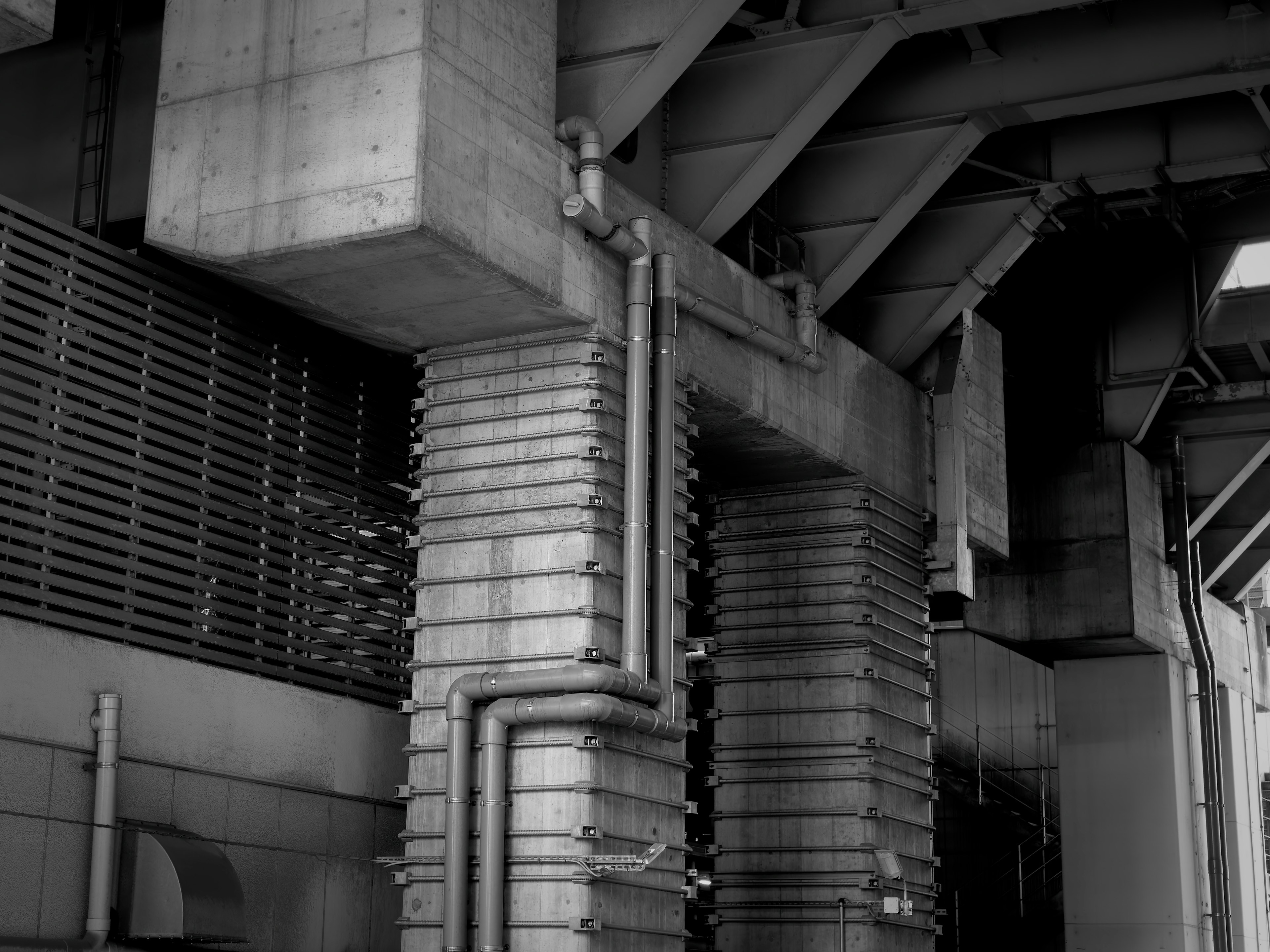 A section of a structure featuring concrete pillars and pipes