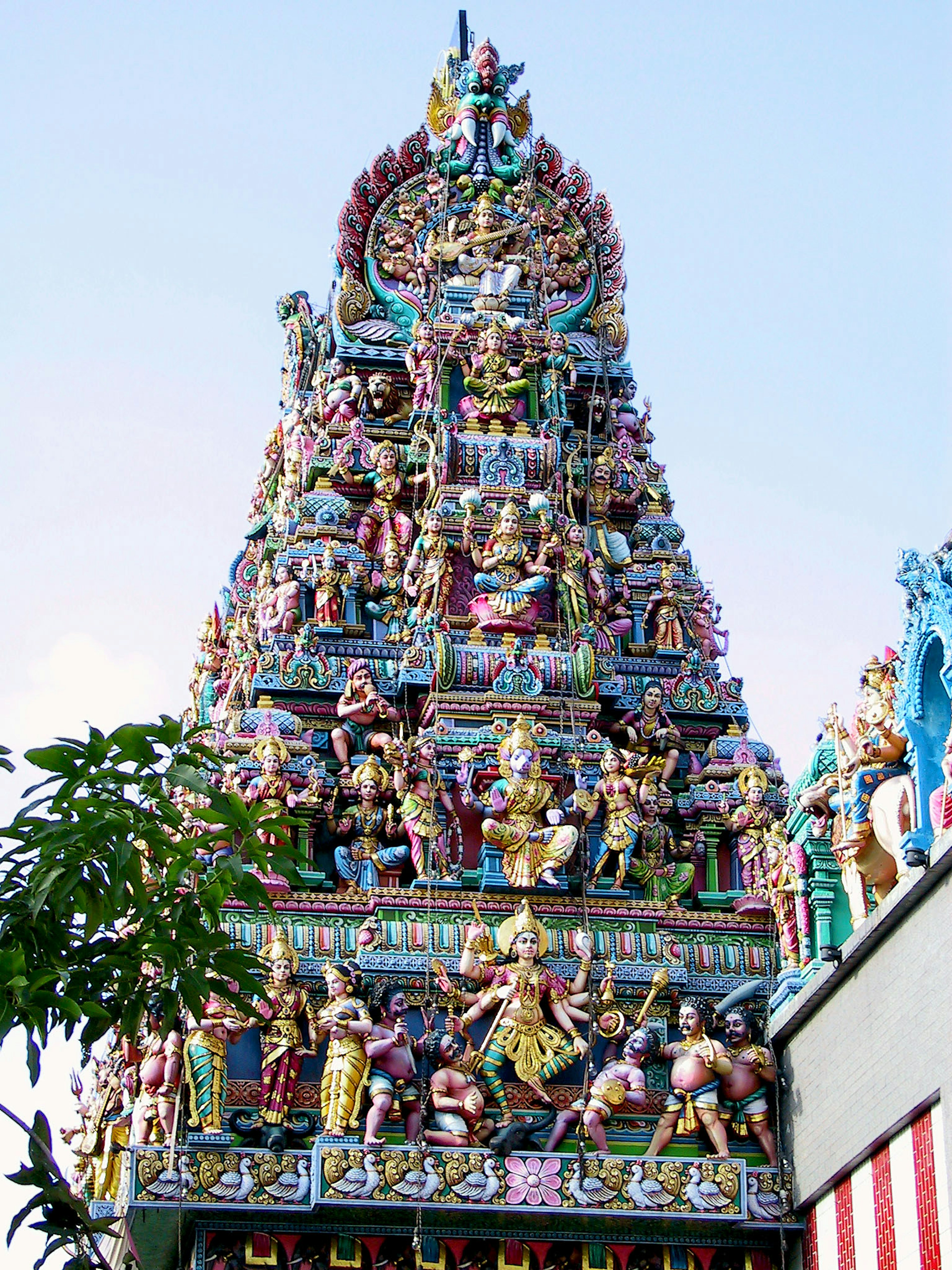 Detailed view of a temple tower adorned with colorful sculptures