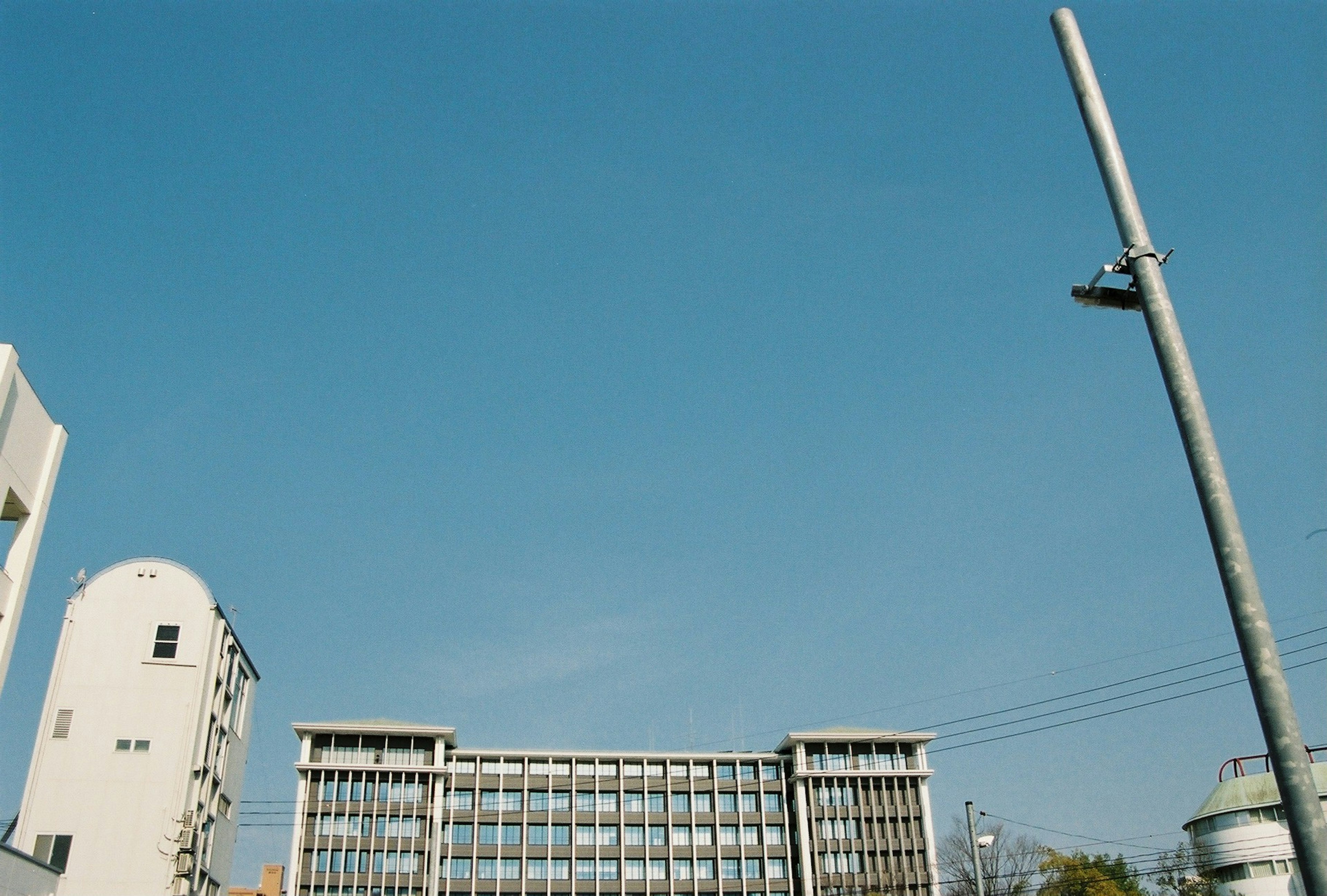 Modern building and streetlight under a clear blue sky