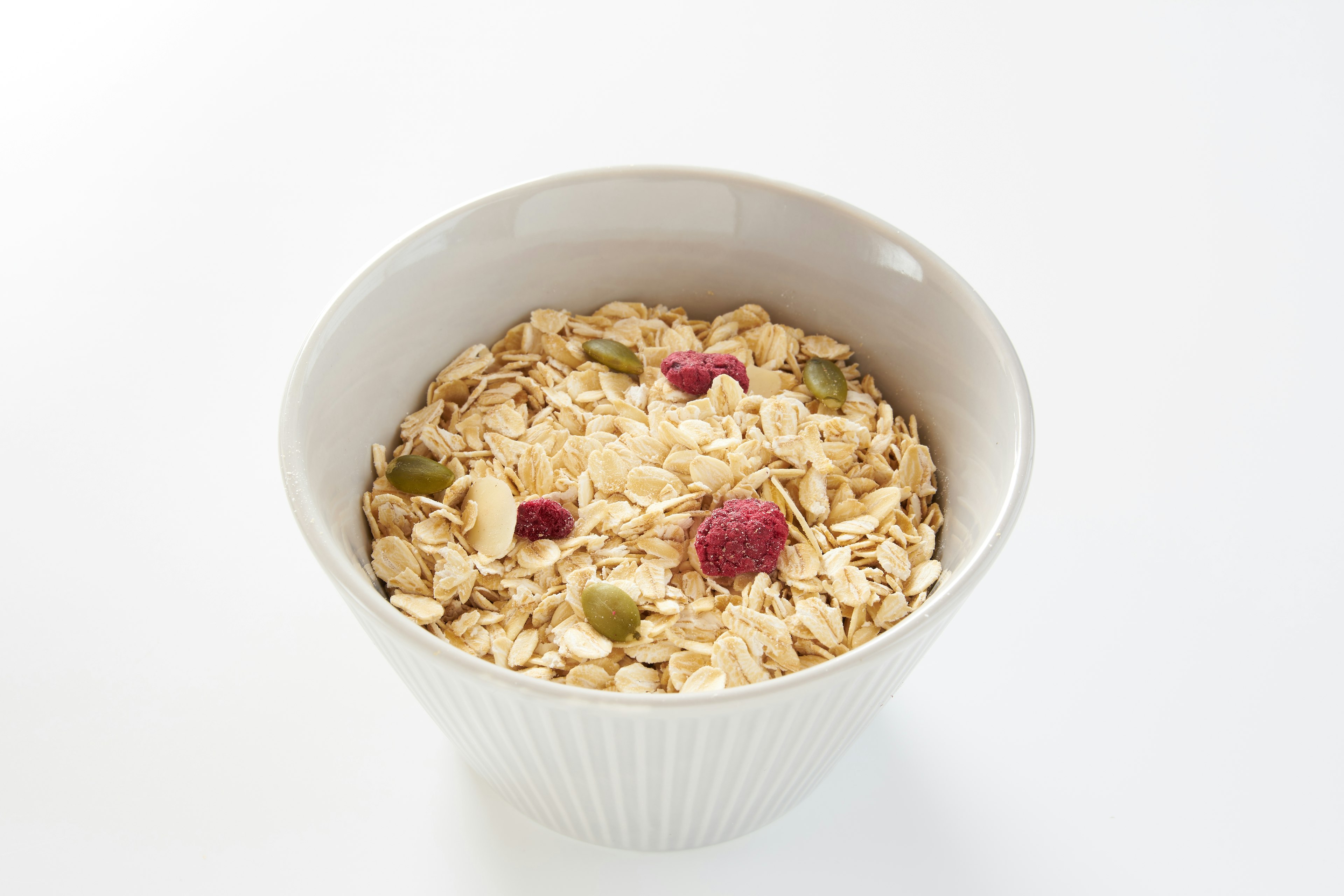 Oatmeal with dried fruits in a white bowl