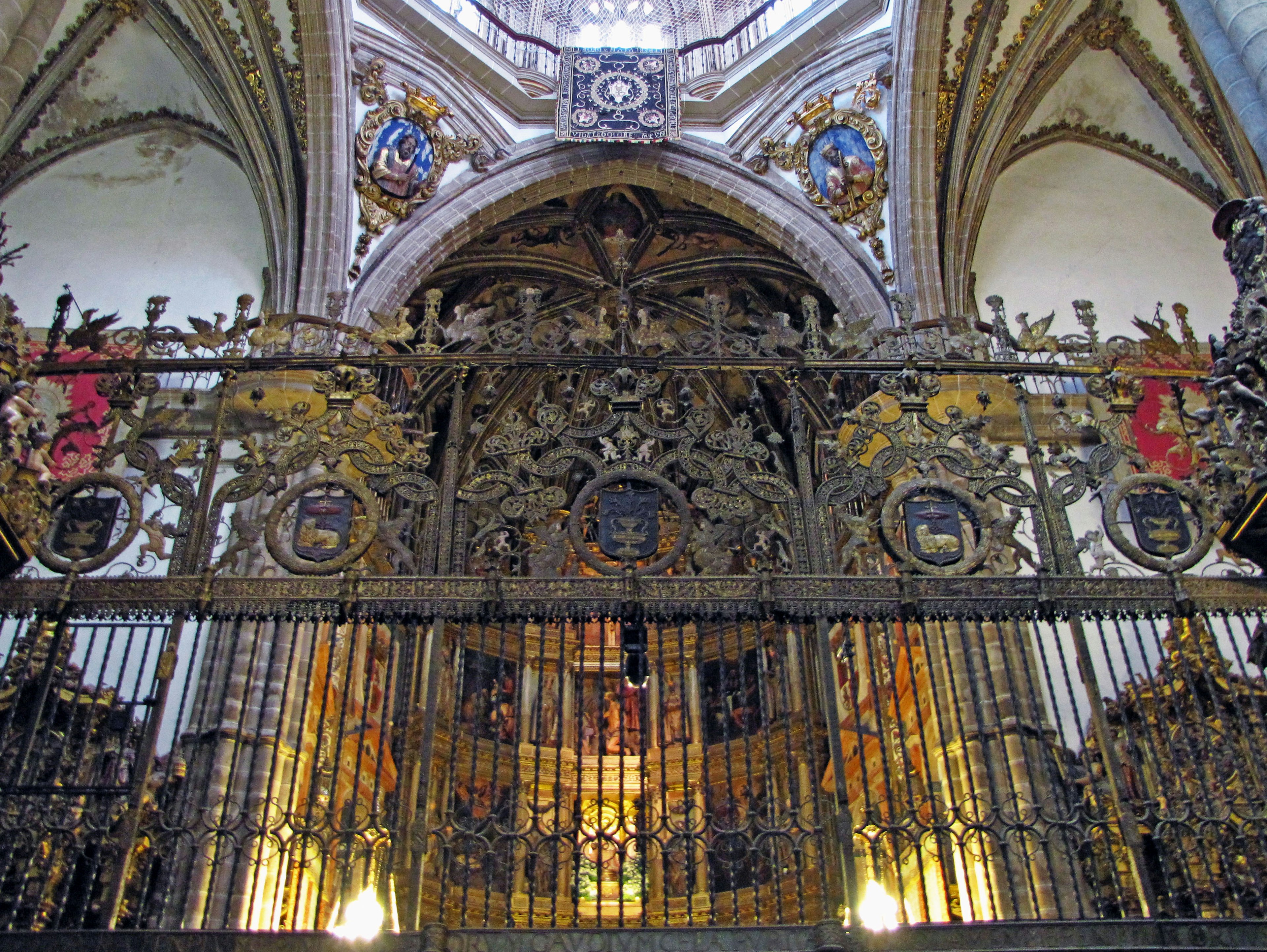 Puerta de iglesia decorada con hierro forjado y arte en el techo