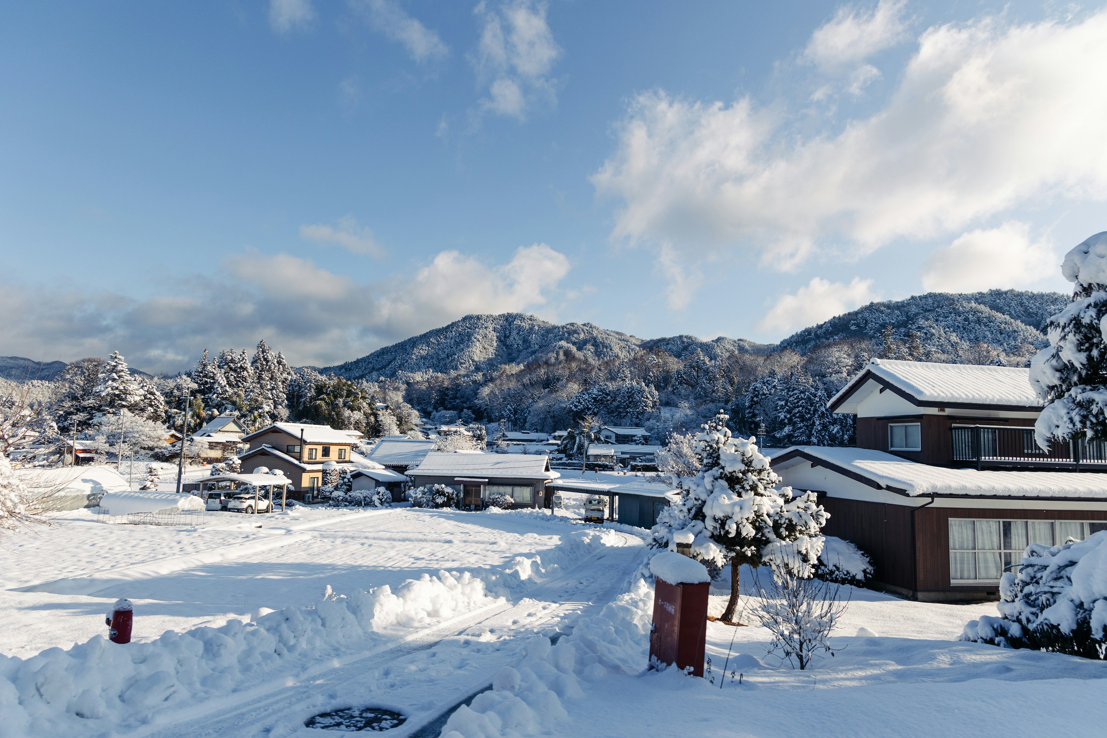 Snow-covered landscape with mountains under a blue sky