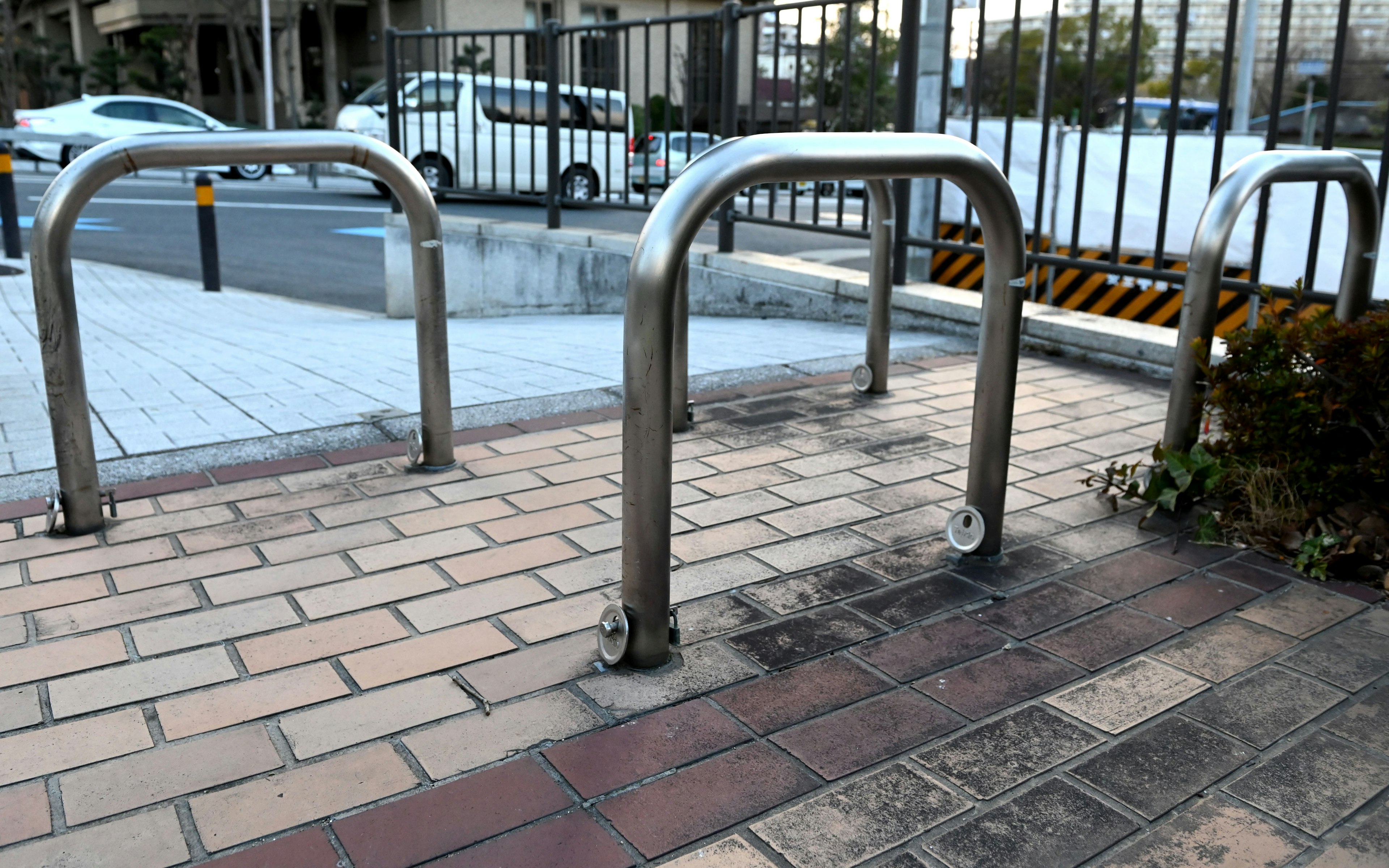 A row of metal bicycle racks on a sidewalk