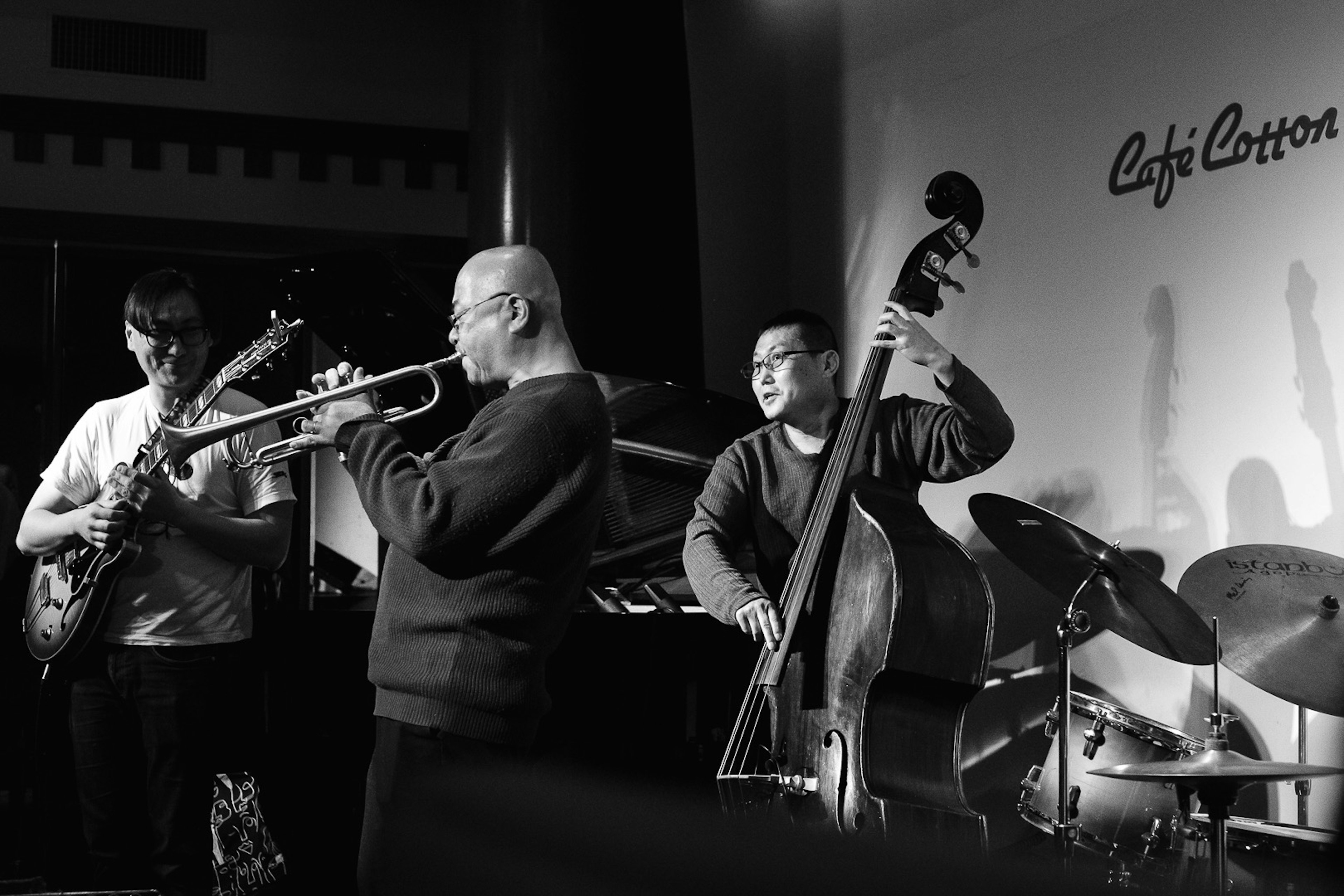 Imagen en blanco y negro de una banda de jazz tocando con un trompetista y un contrabajista