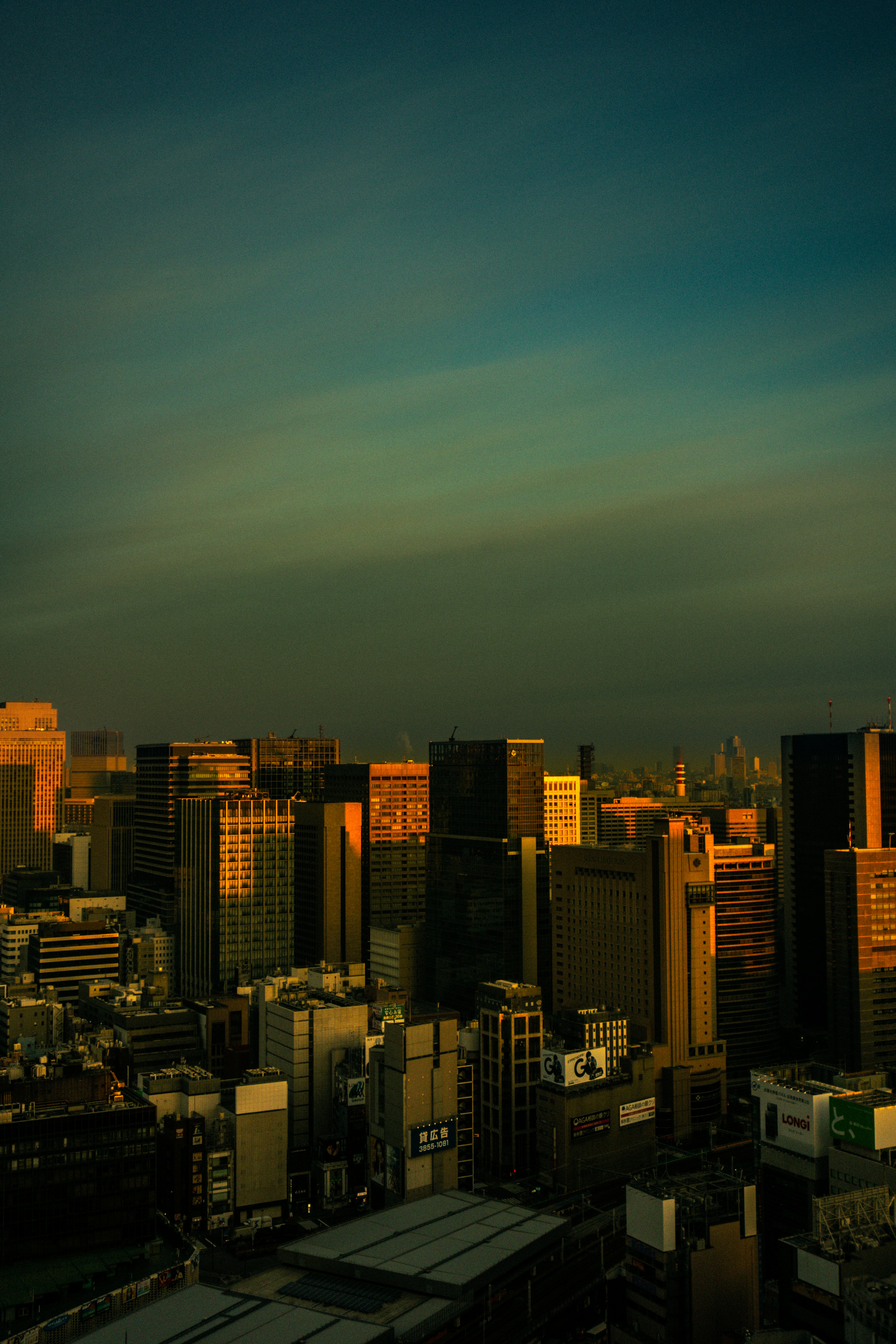 City skyline at dusk with skyscrapers and a colorful sky