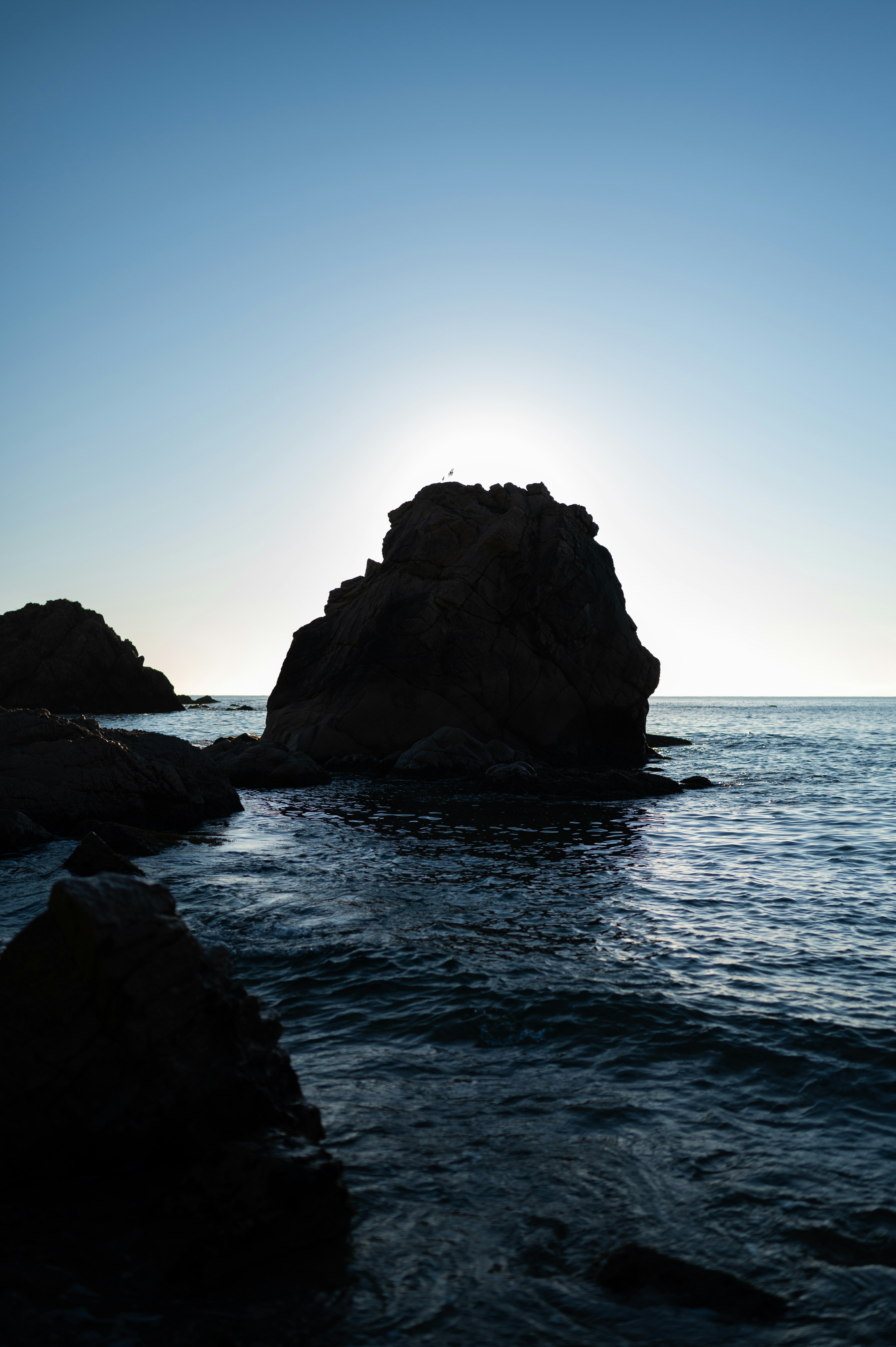 海と岩のシルエットが美しい夕暮れの景色