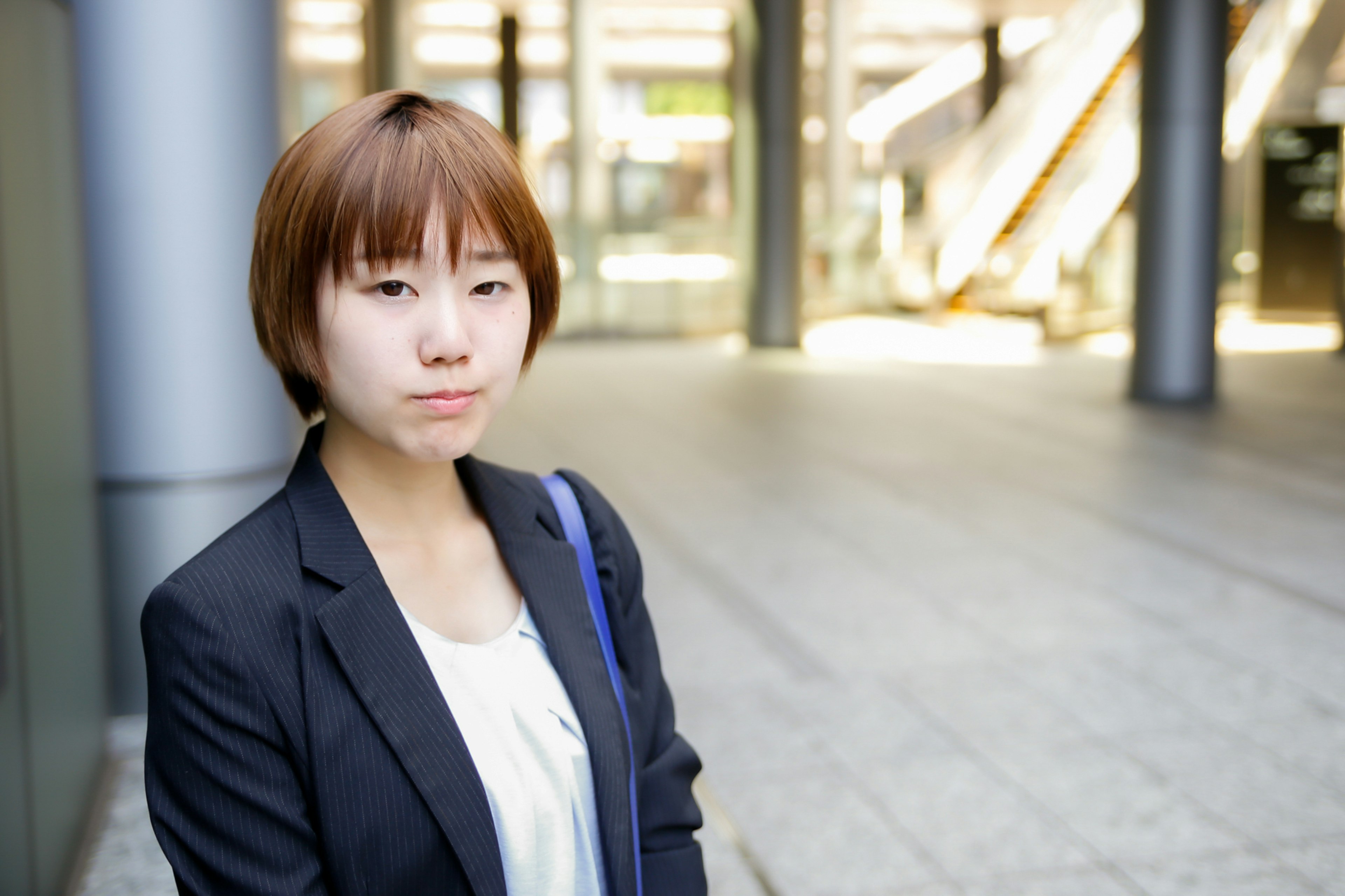 A woman in a business suit standing in an urban setting