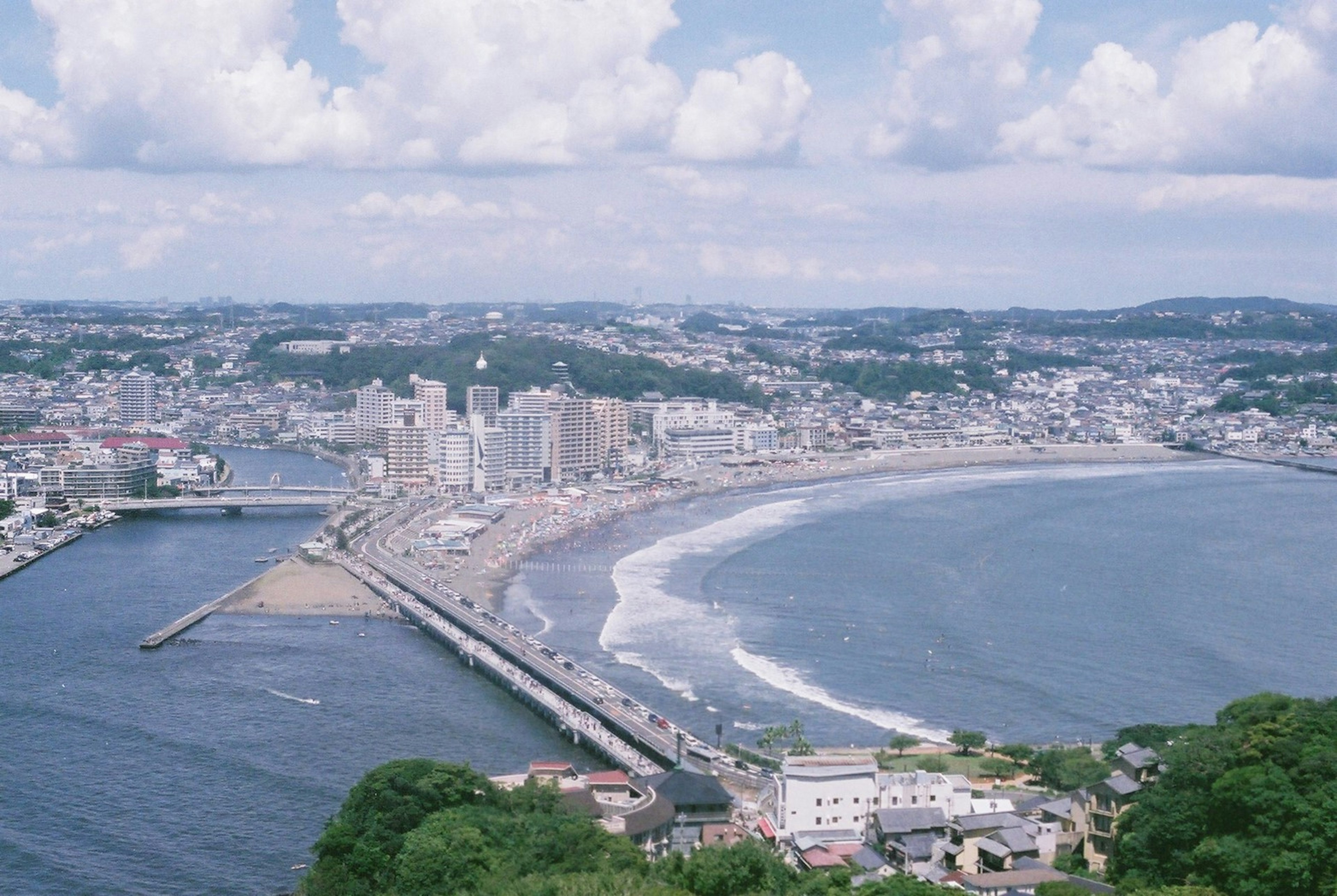 Coastal cityscape with blue sky and clouds