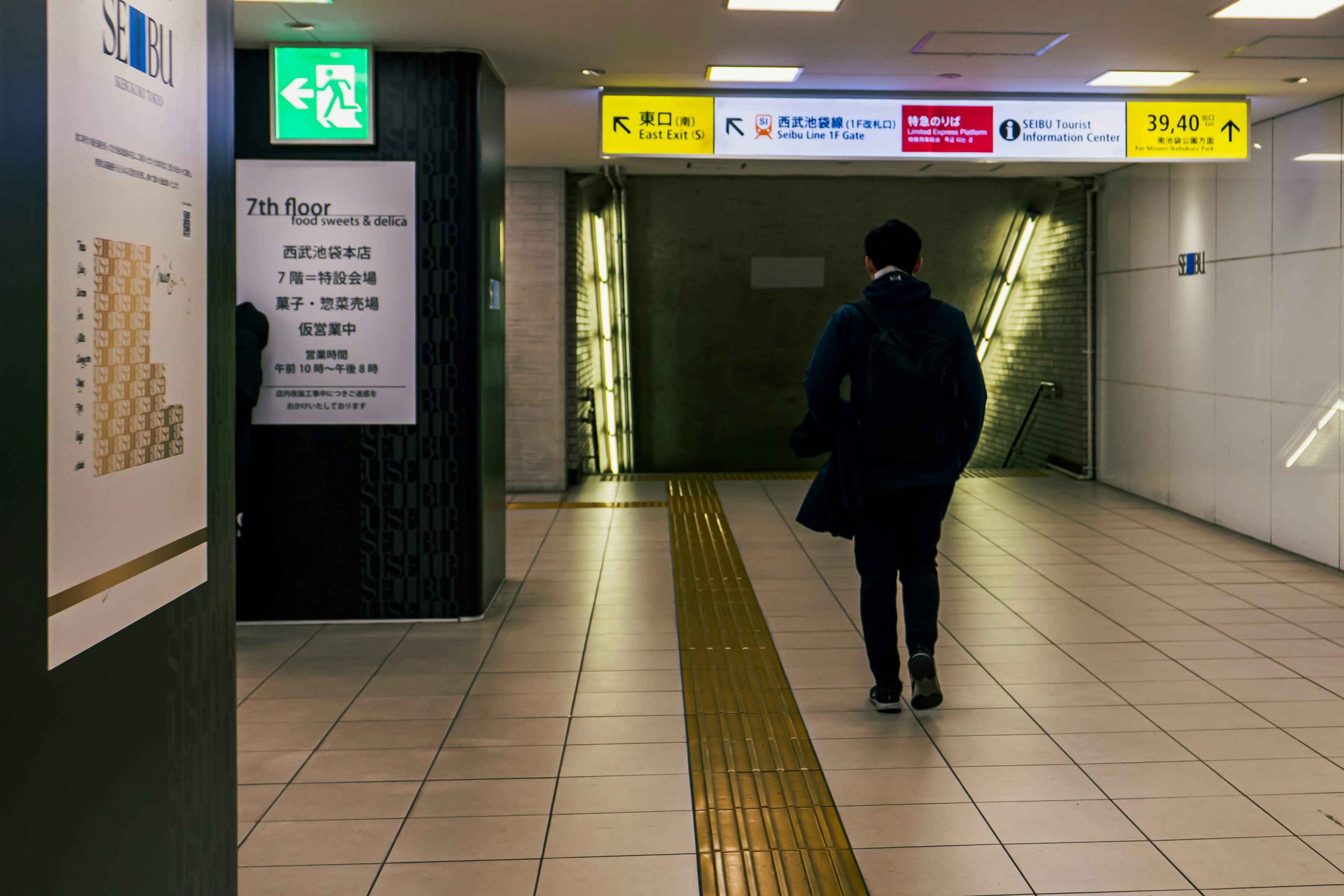 Persona caminando hacia la salida del metro con iluminación brillante