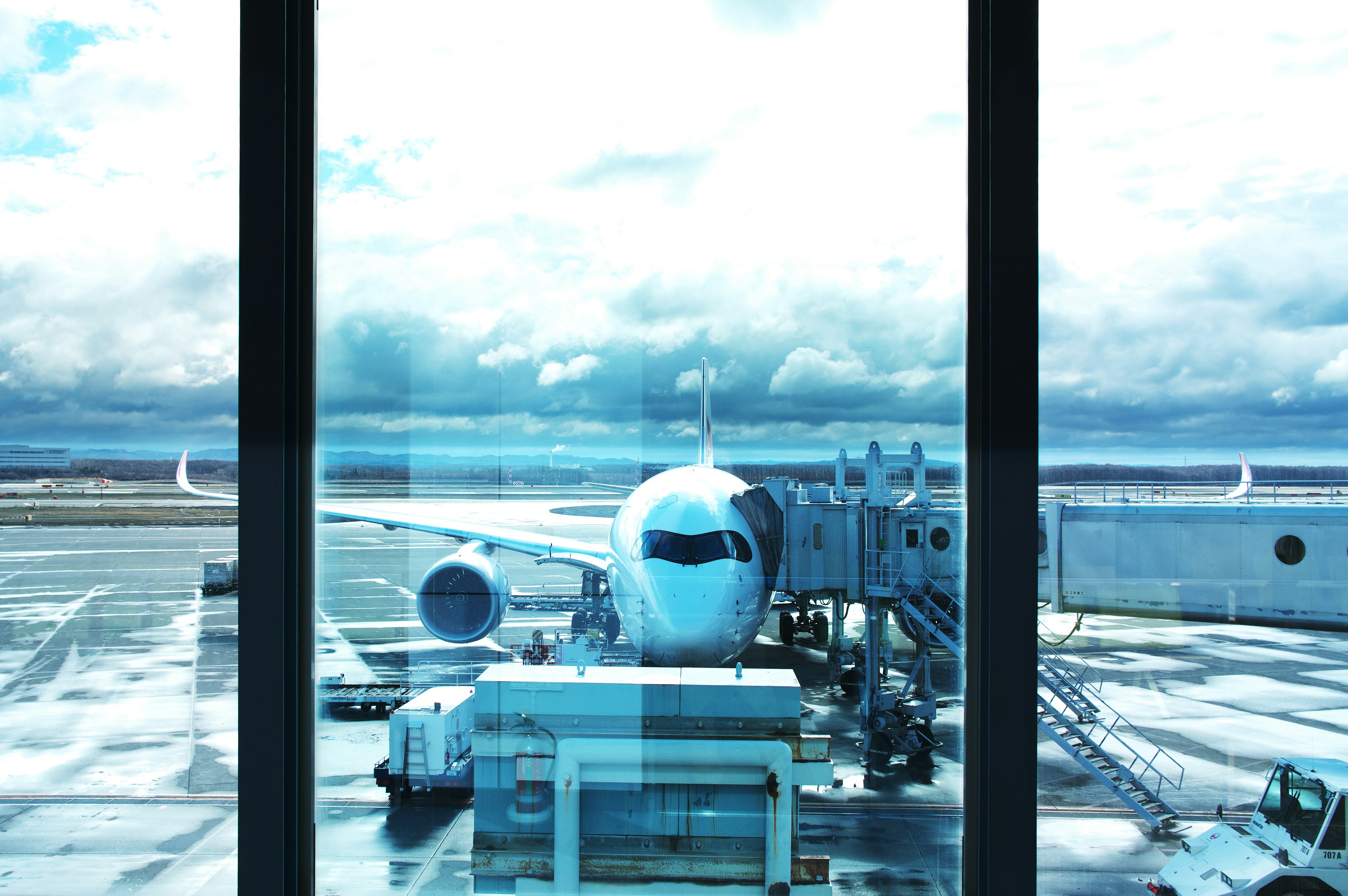 Vue d'un avion et d'une piste depuis une fenêtre d'aéroport