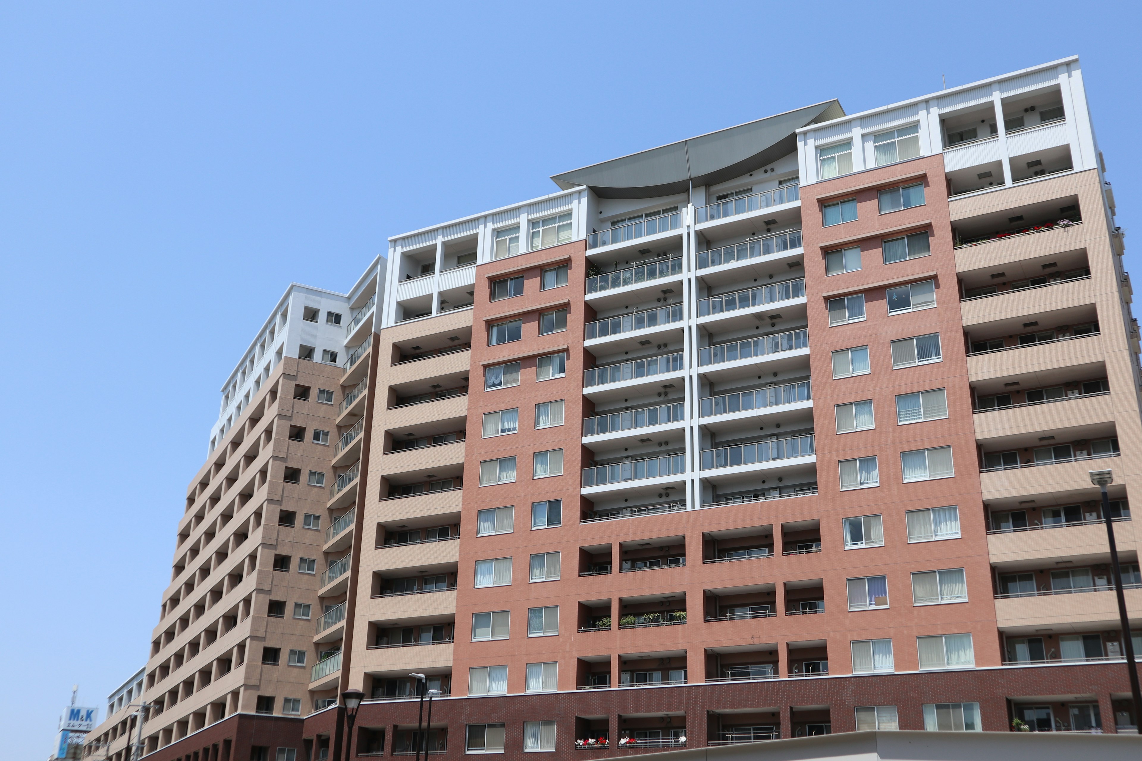 High-rise apartment building under a blue sky