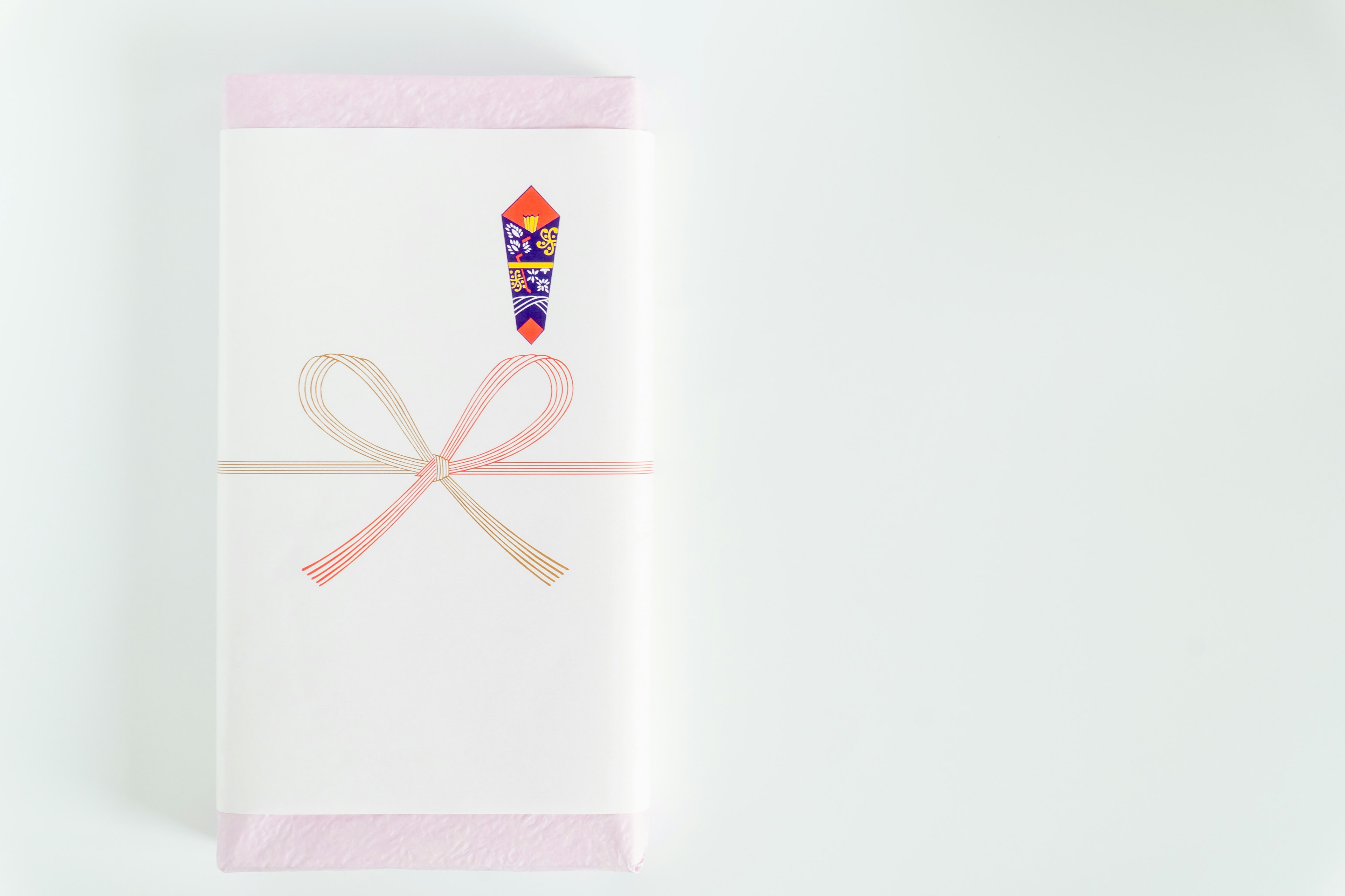 A white package tied with a pink ribbon featuring an ice cream sticker