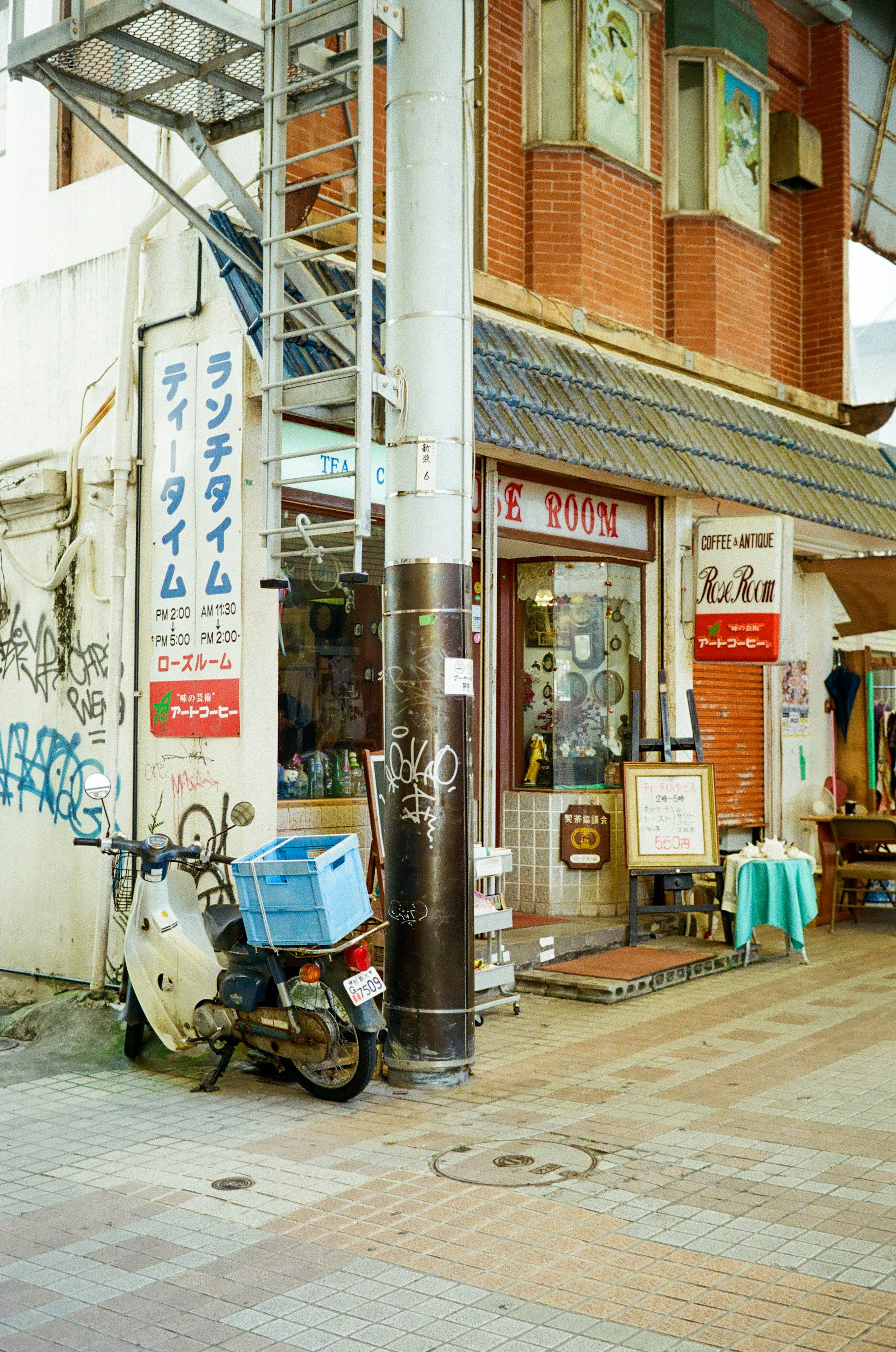 街角の小さな店舗とバイクのある風景