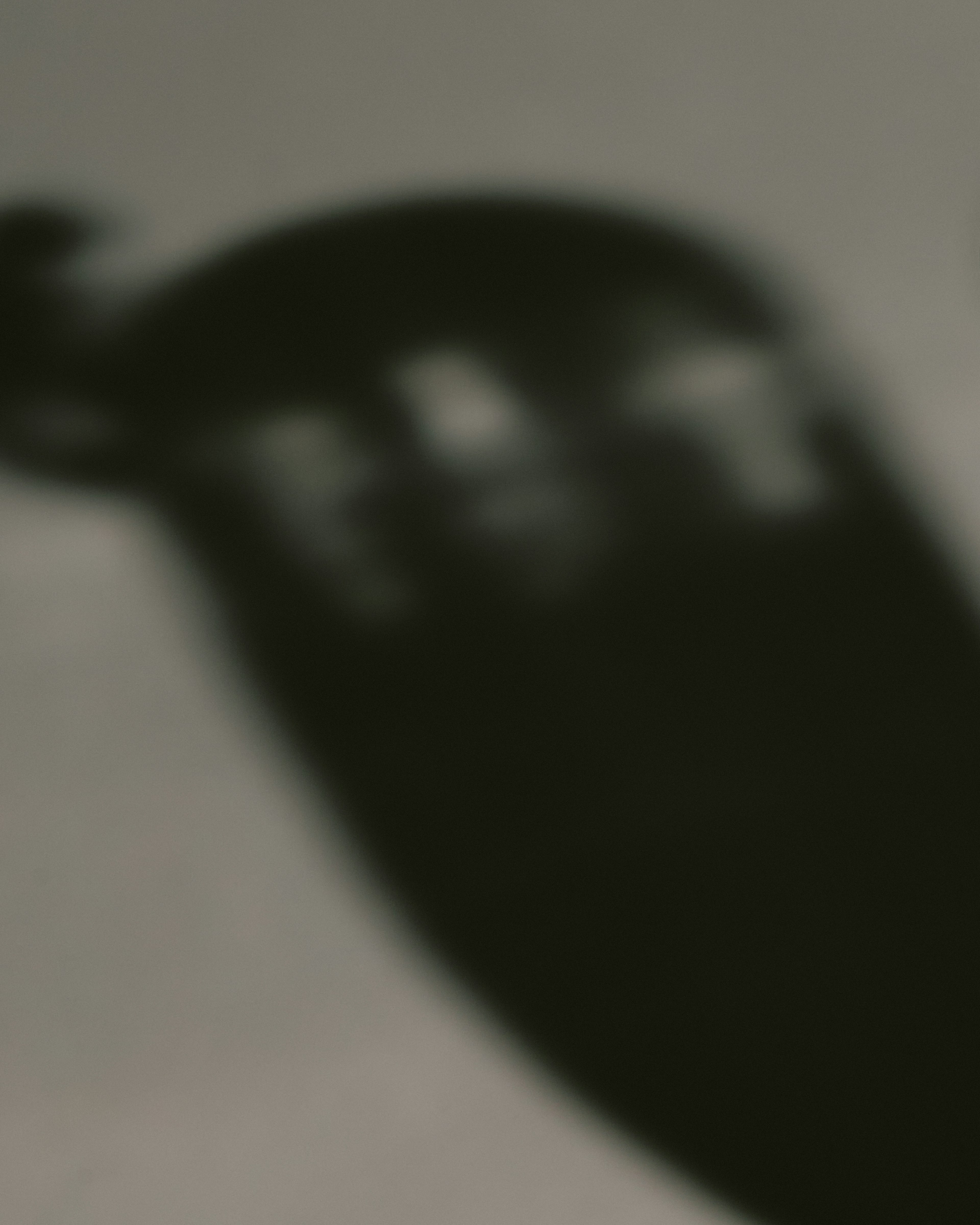 Blurred image of a dark object with reflections