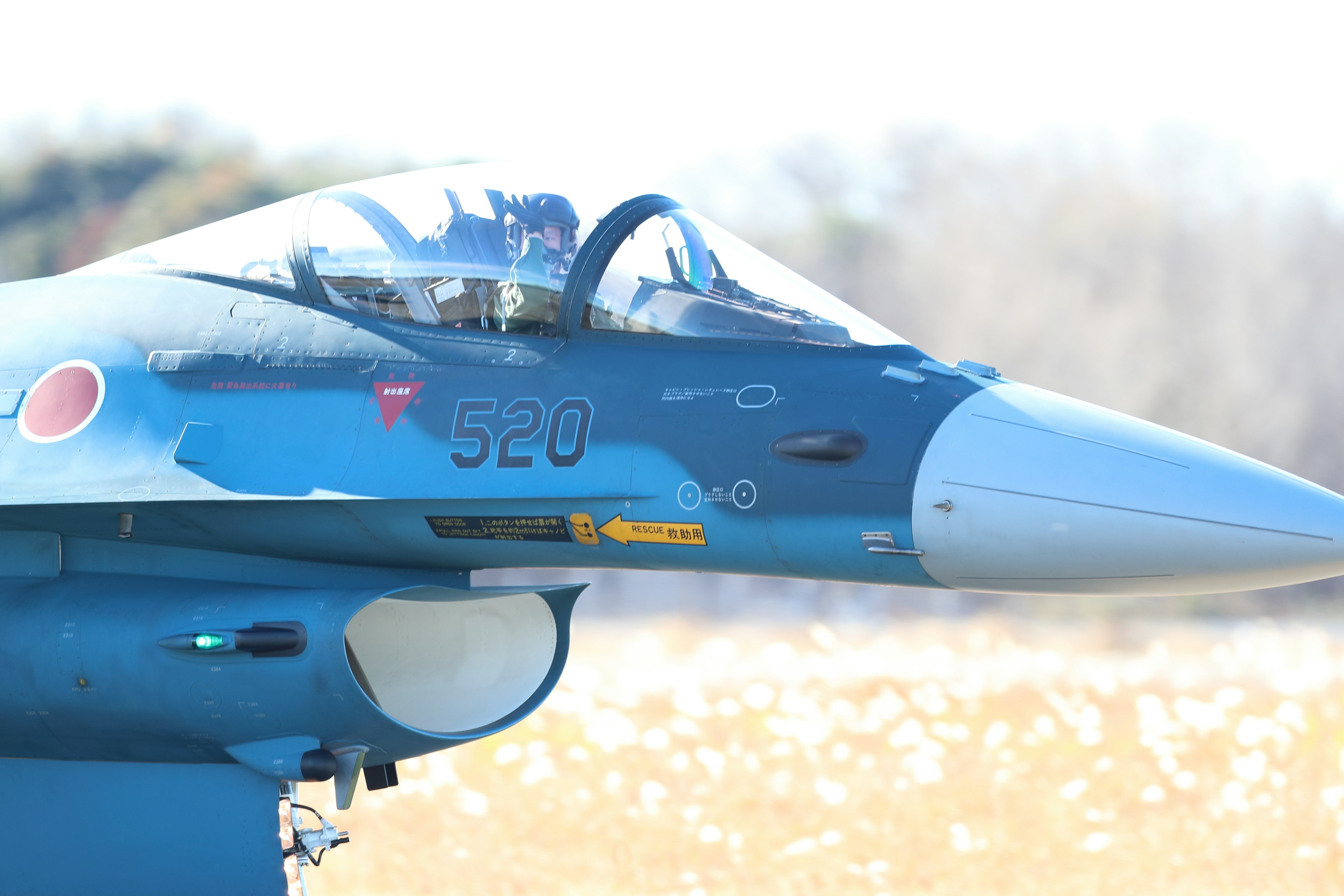 Nahaufnahme des Cockpits eines blauen Kampfjets mit der Nummer 520