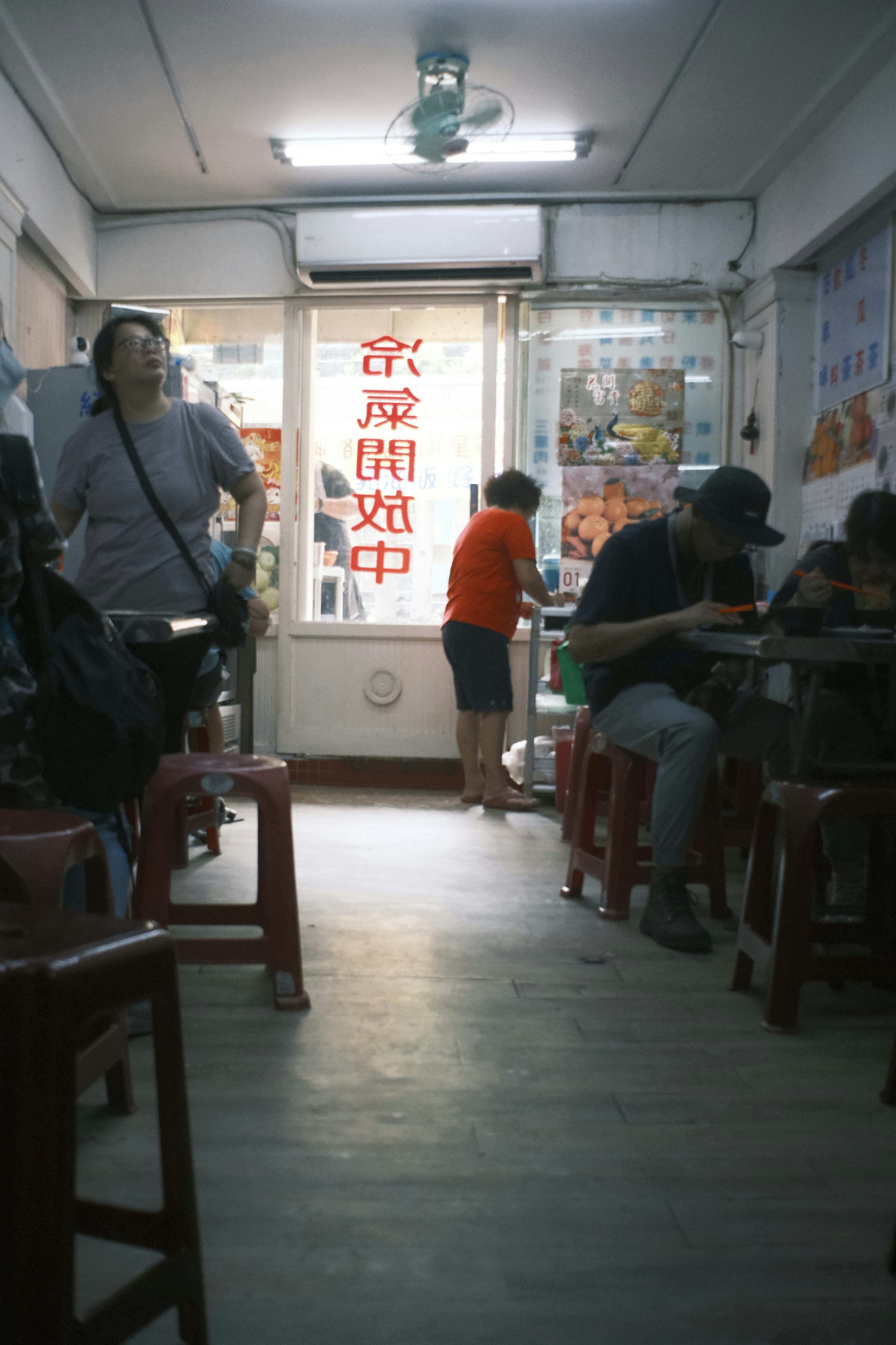 Interior of a casual eatery with people dining and an open door