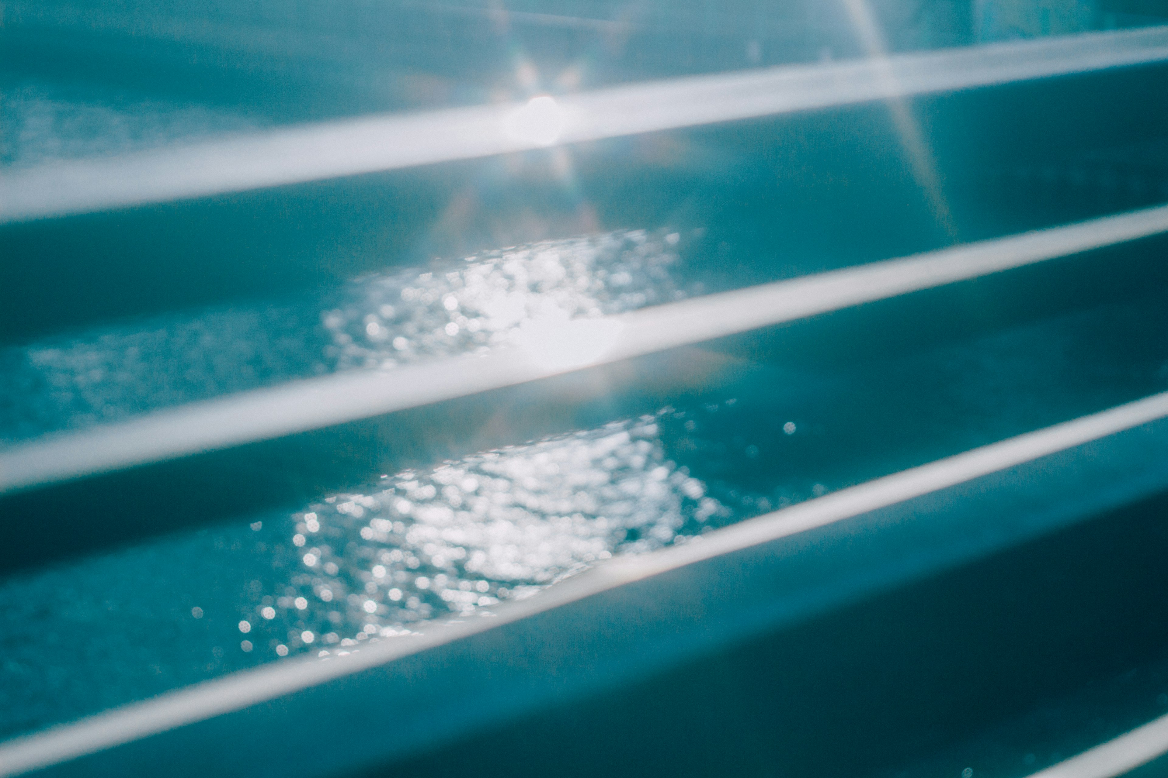 Reflection of light on water with blue striped structure