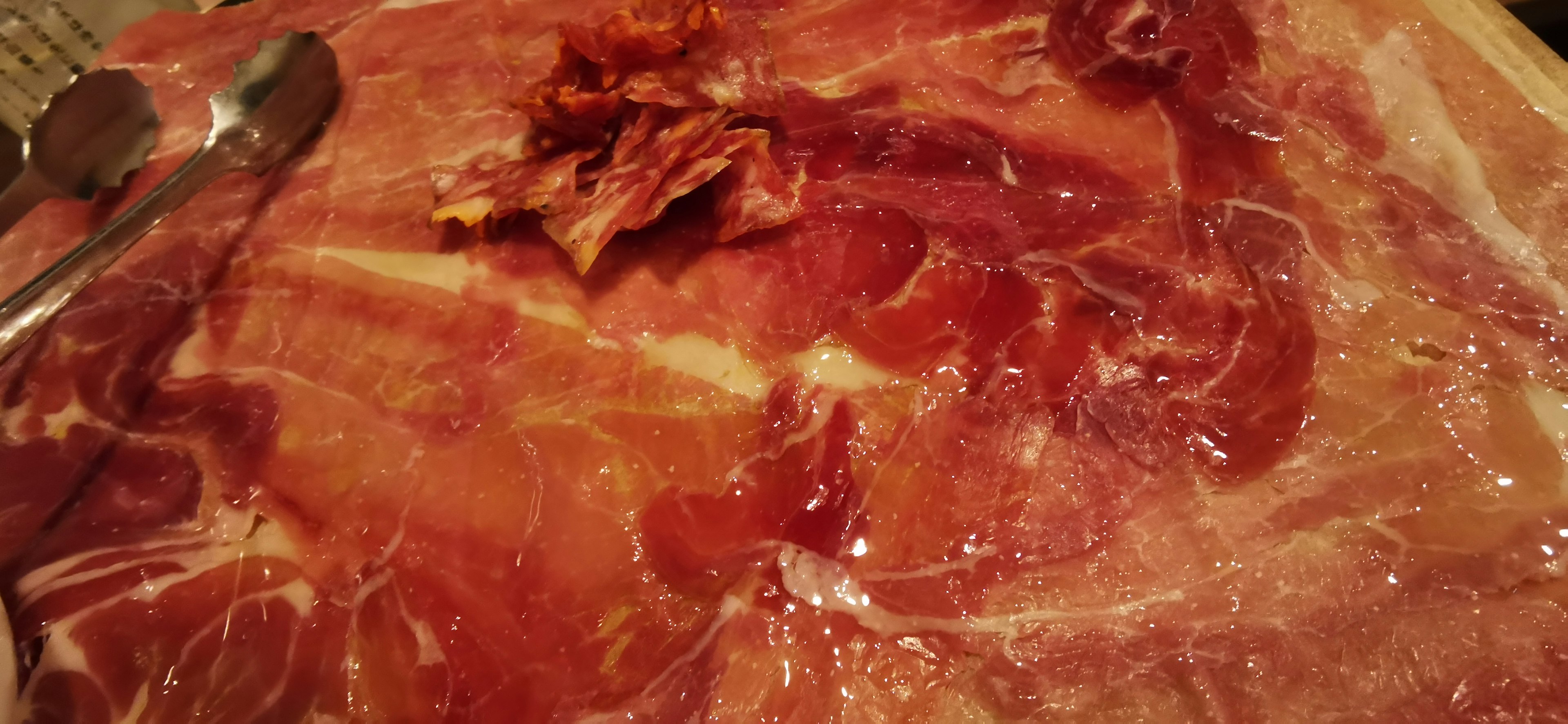 Slices of prosciutto arranged on a plate