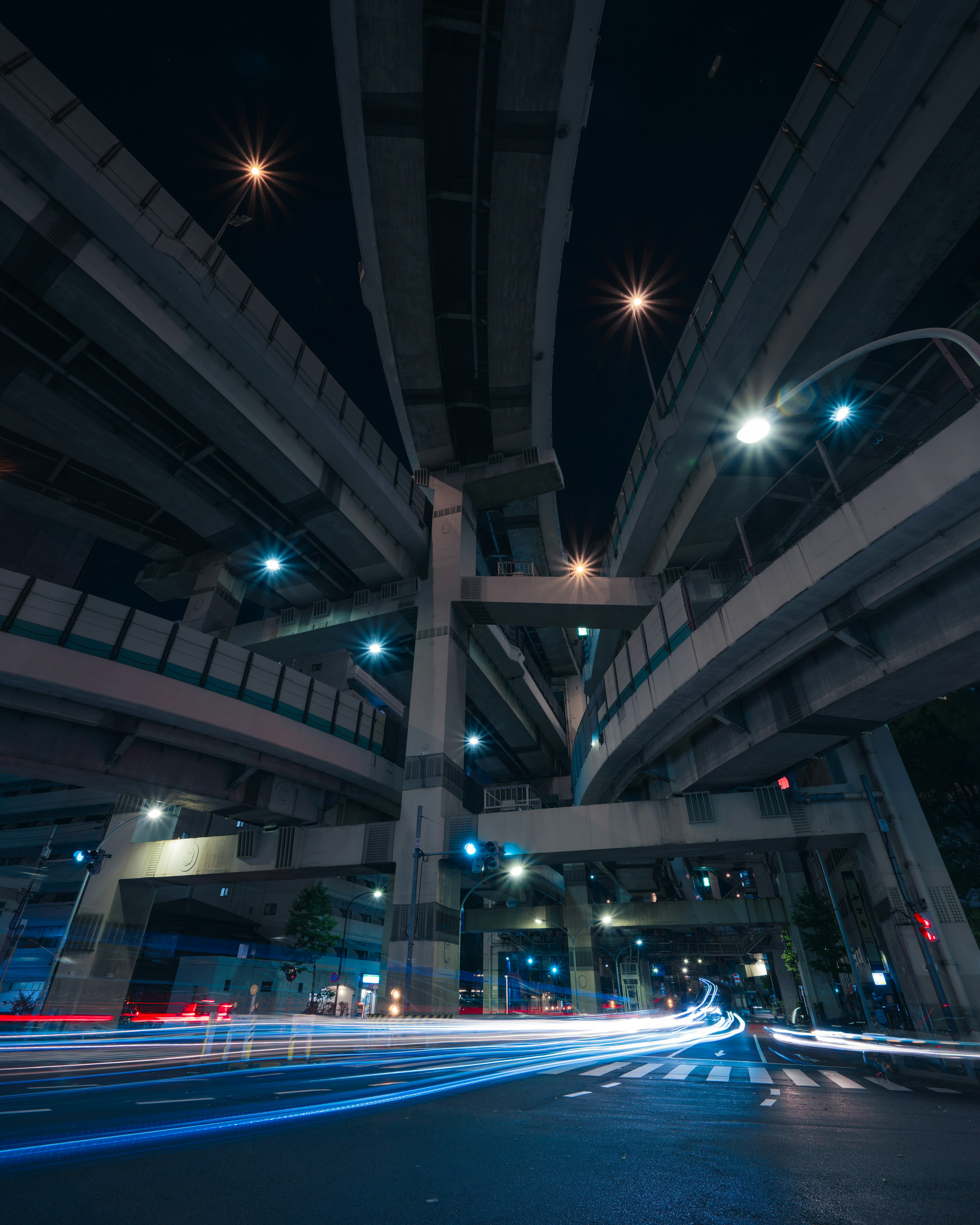 Night cityscape with intersecting highways visible light trails from vehicles