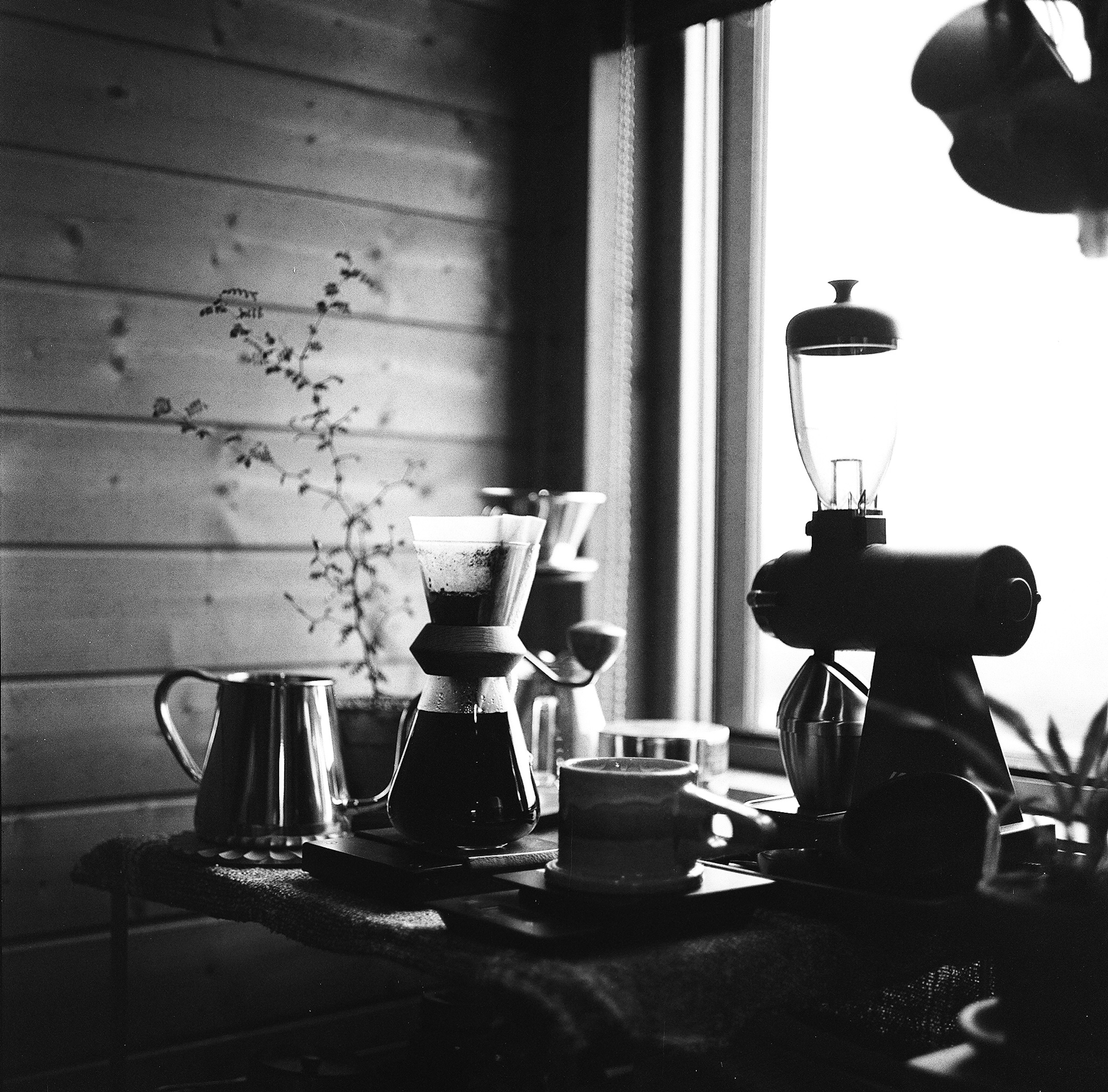 A serene indoor scene featuring coffee brewing equipment