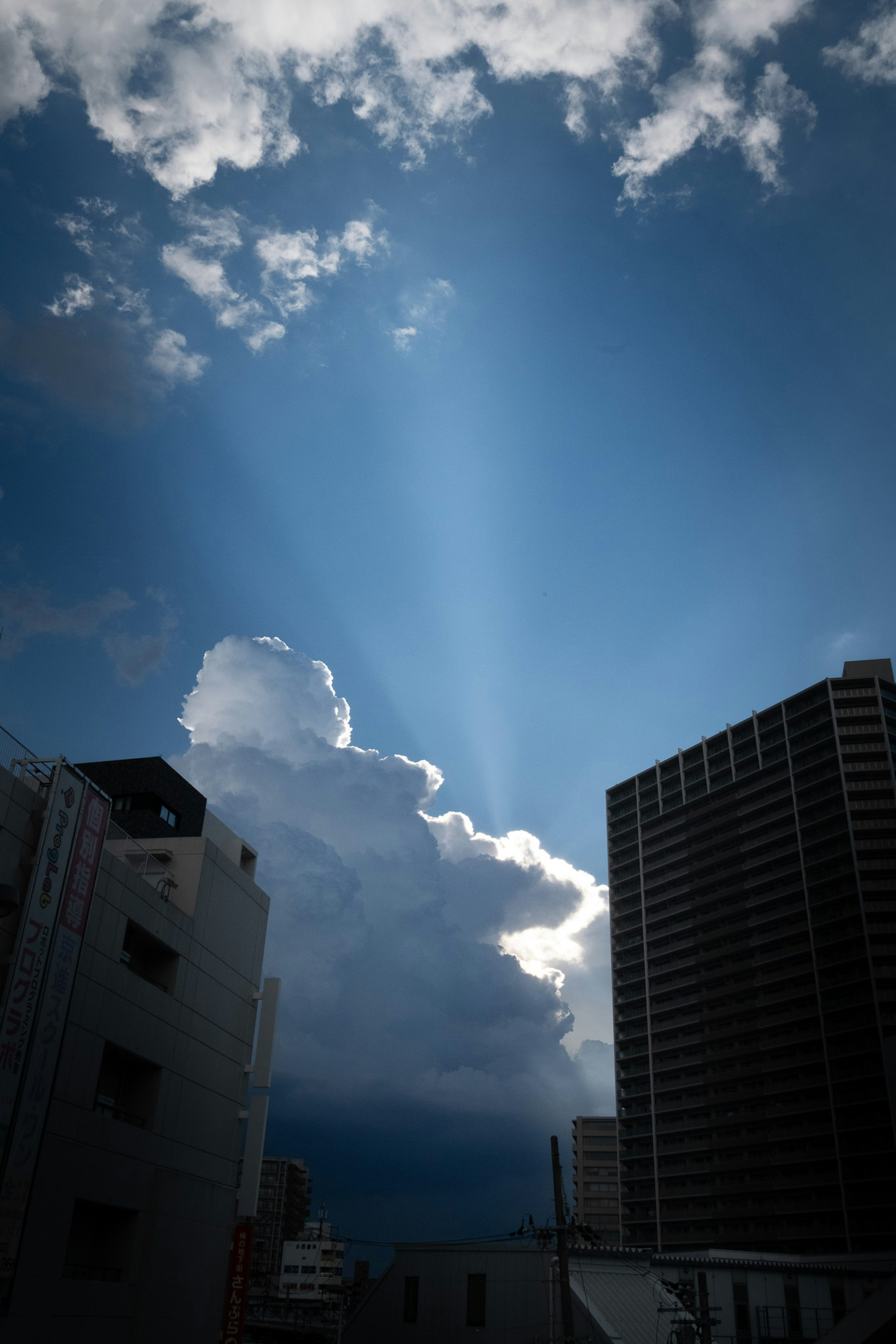 Impressive rays of light breaking through clouds against a blue sky