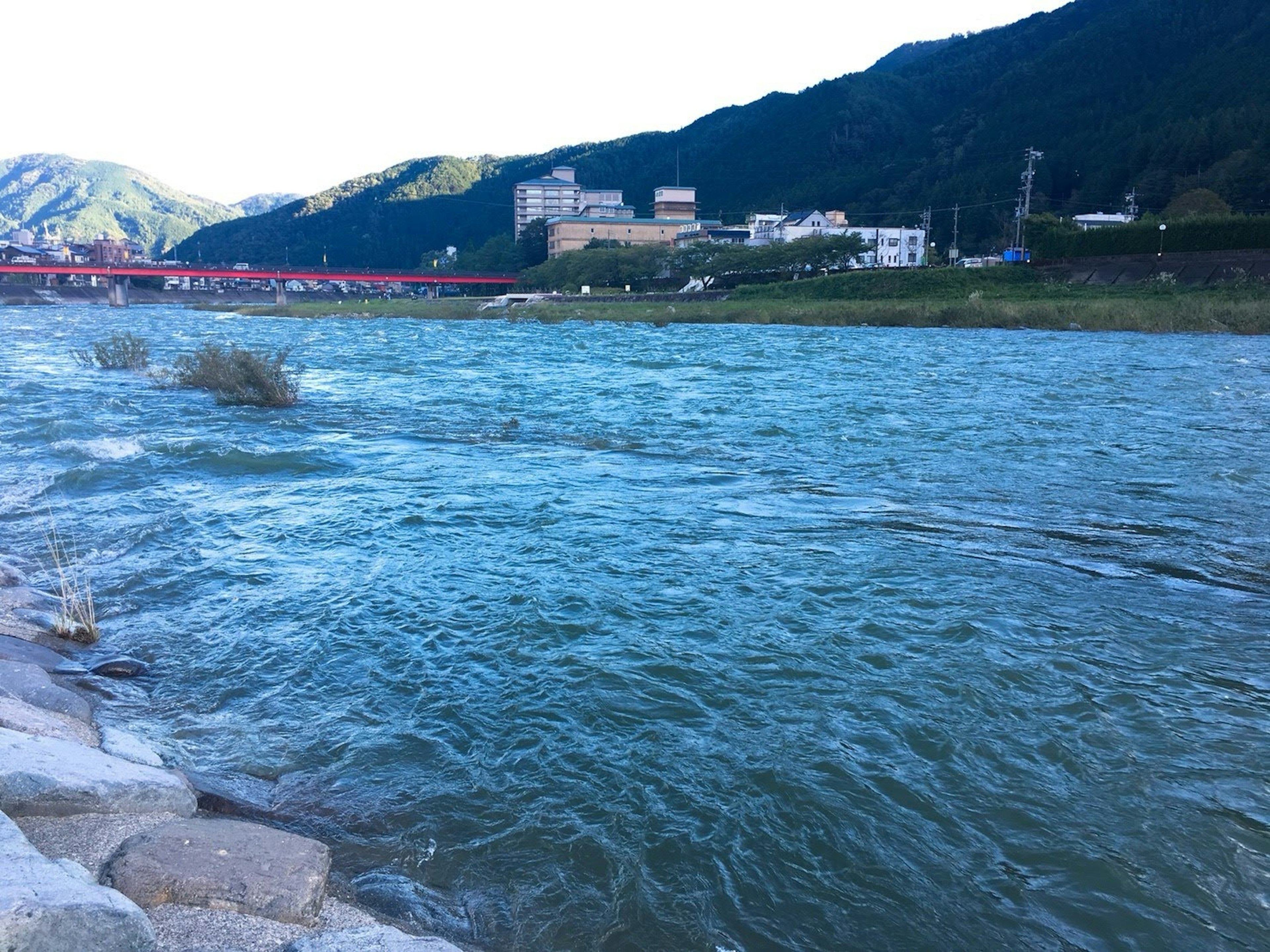 Scenic view of a blue river with mountains in the background