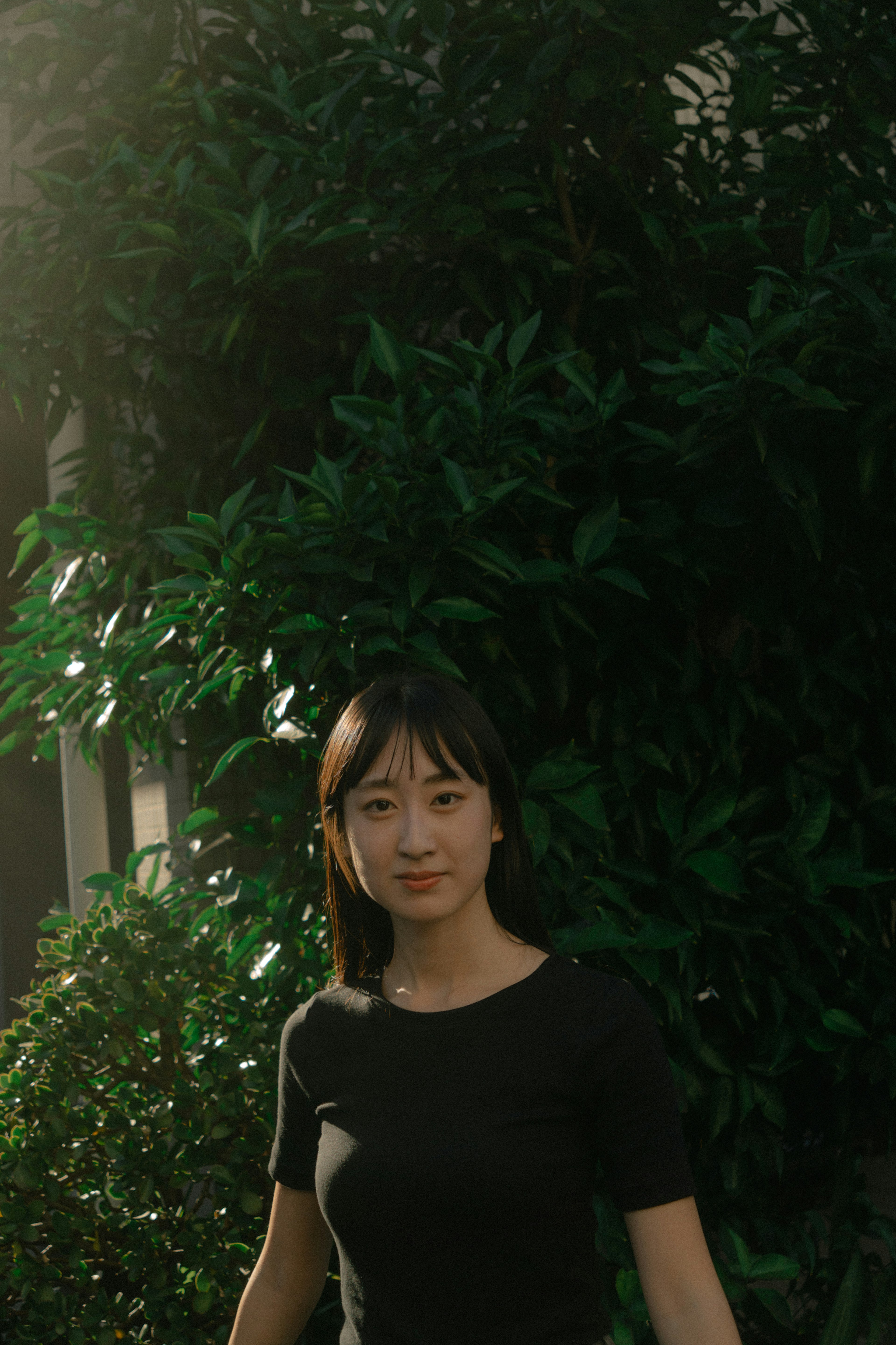 Portrait of a woman standing in front of a green background