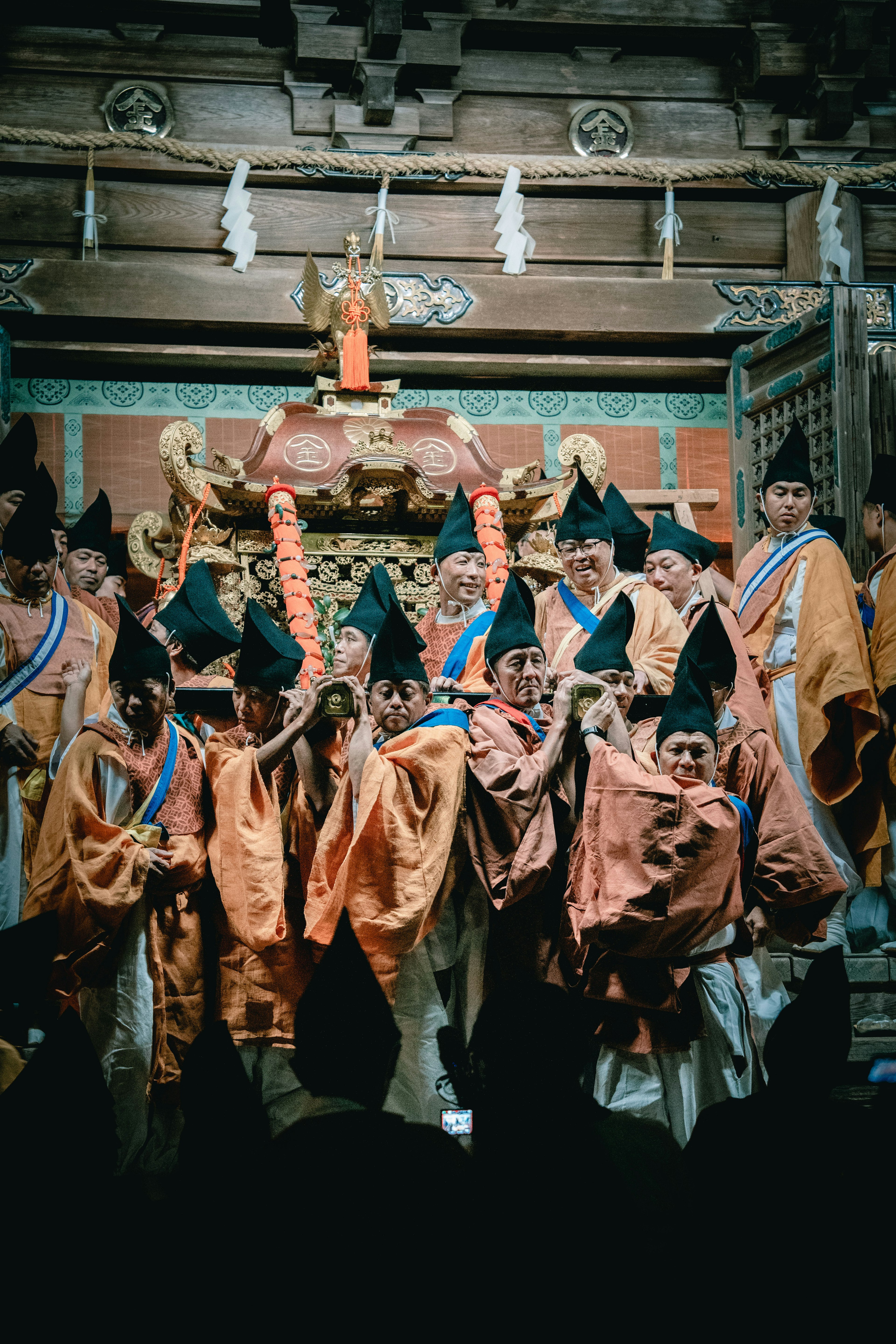 Group of people in traditional attire performing a ritual during a festival