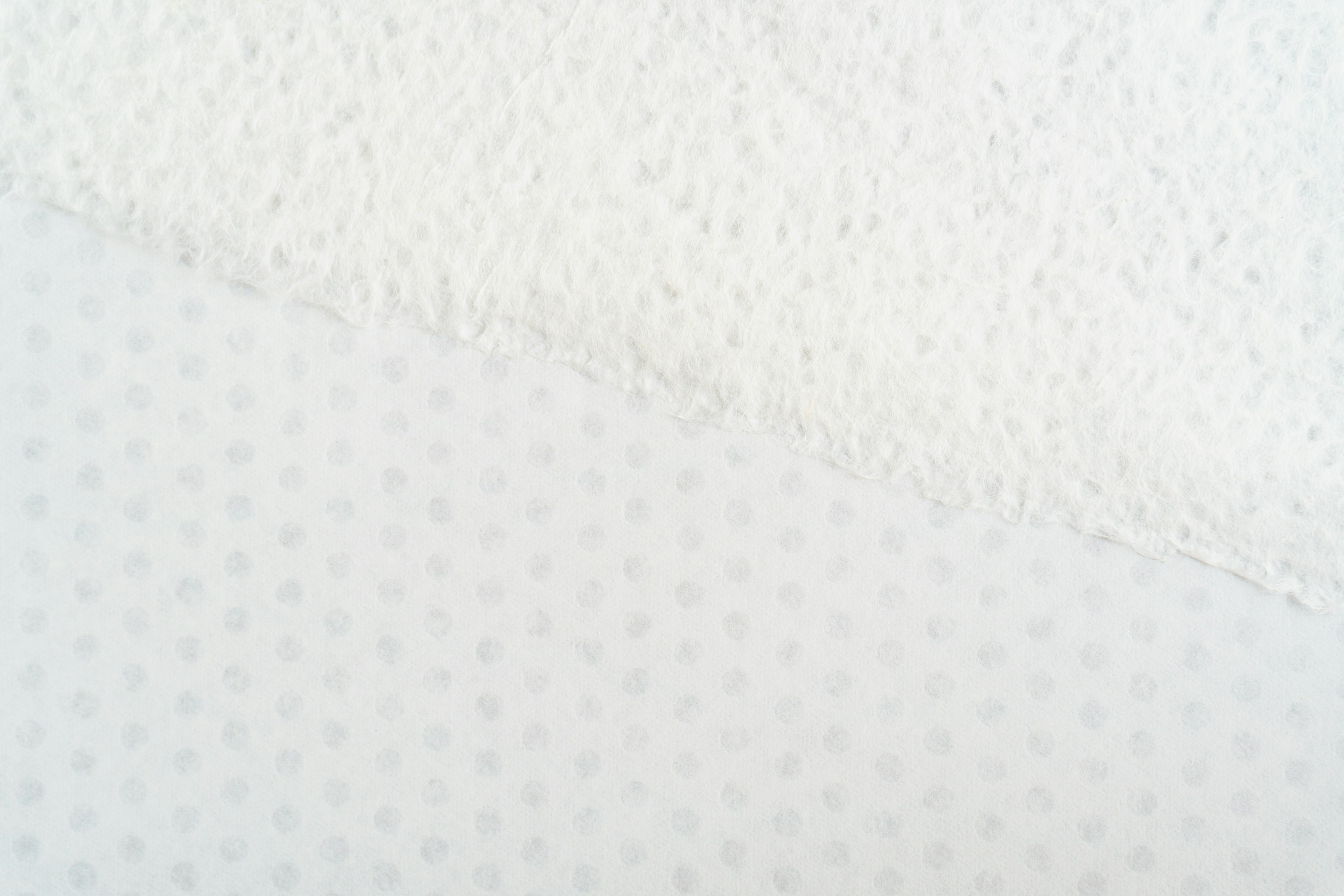 Two different white fabric textures overlapping