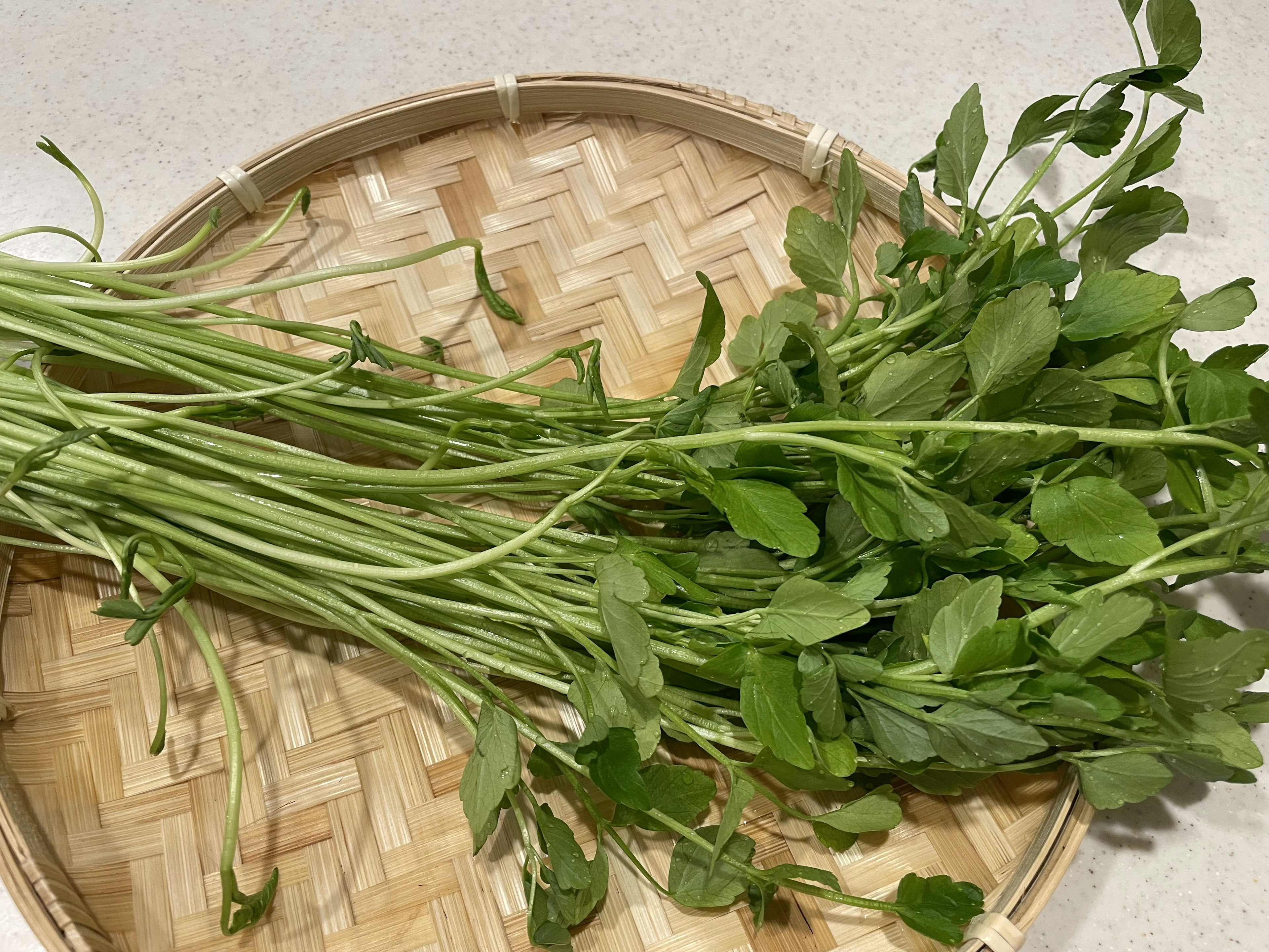 Fresh herbs placed on a woven basket