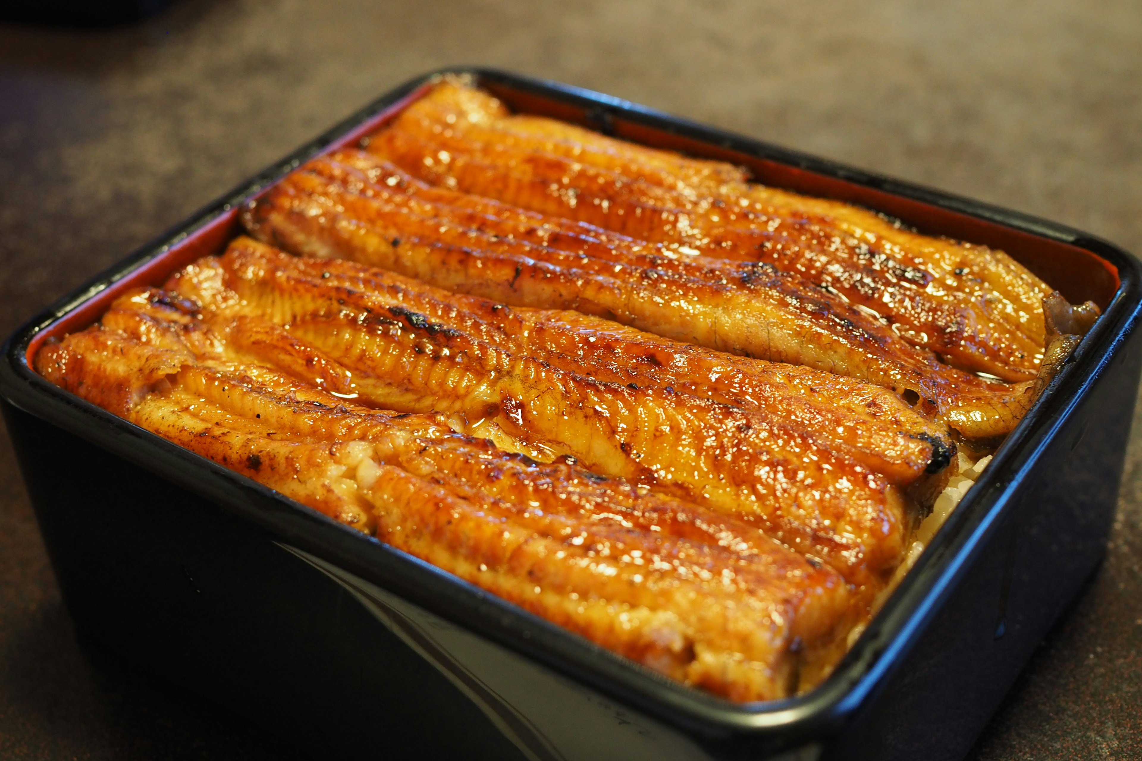 Delicious unajyu with grilled eel served in a black container