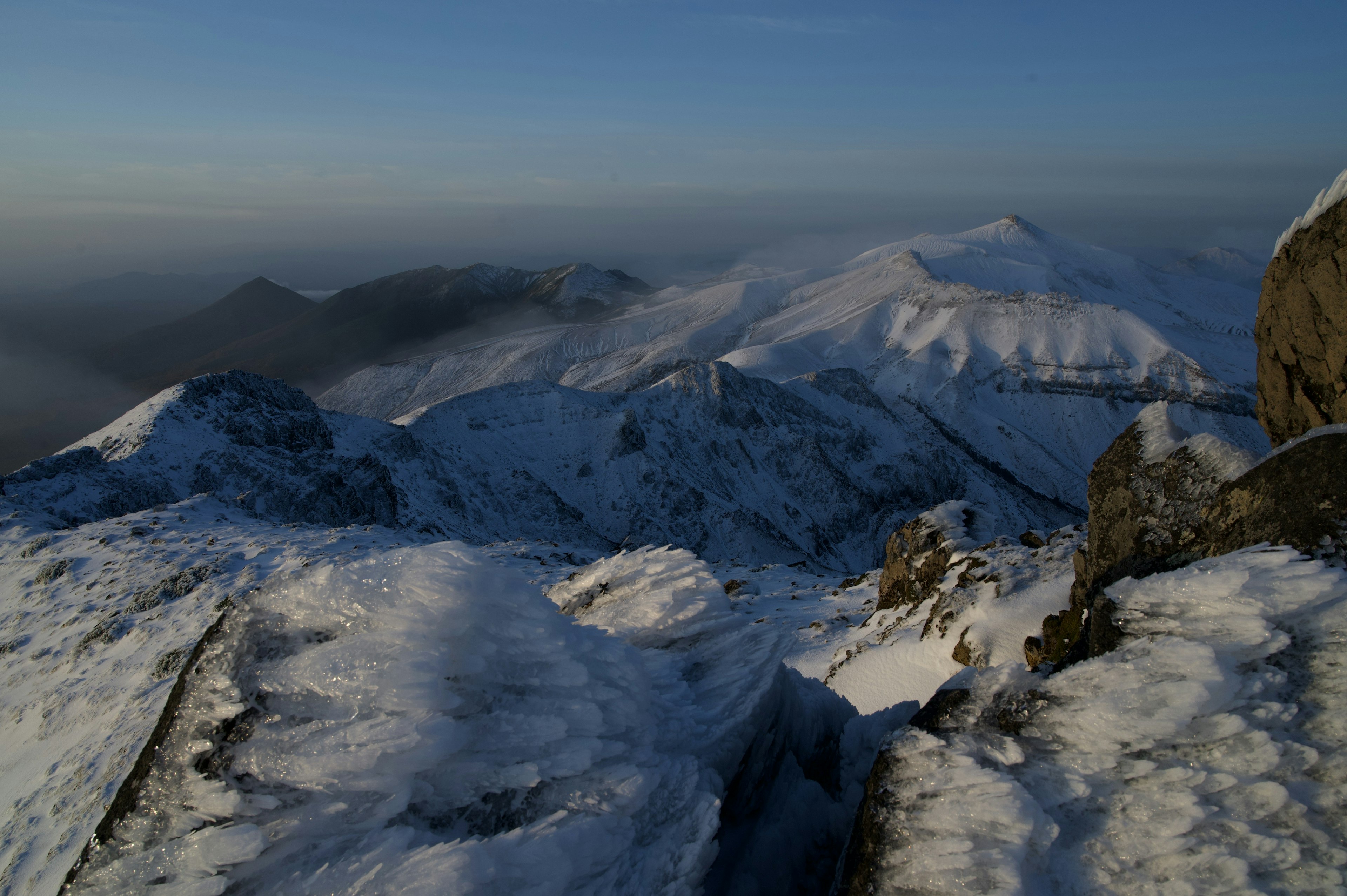 Snow-covered mountains under a clear blue sky