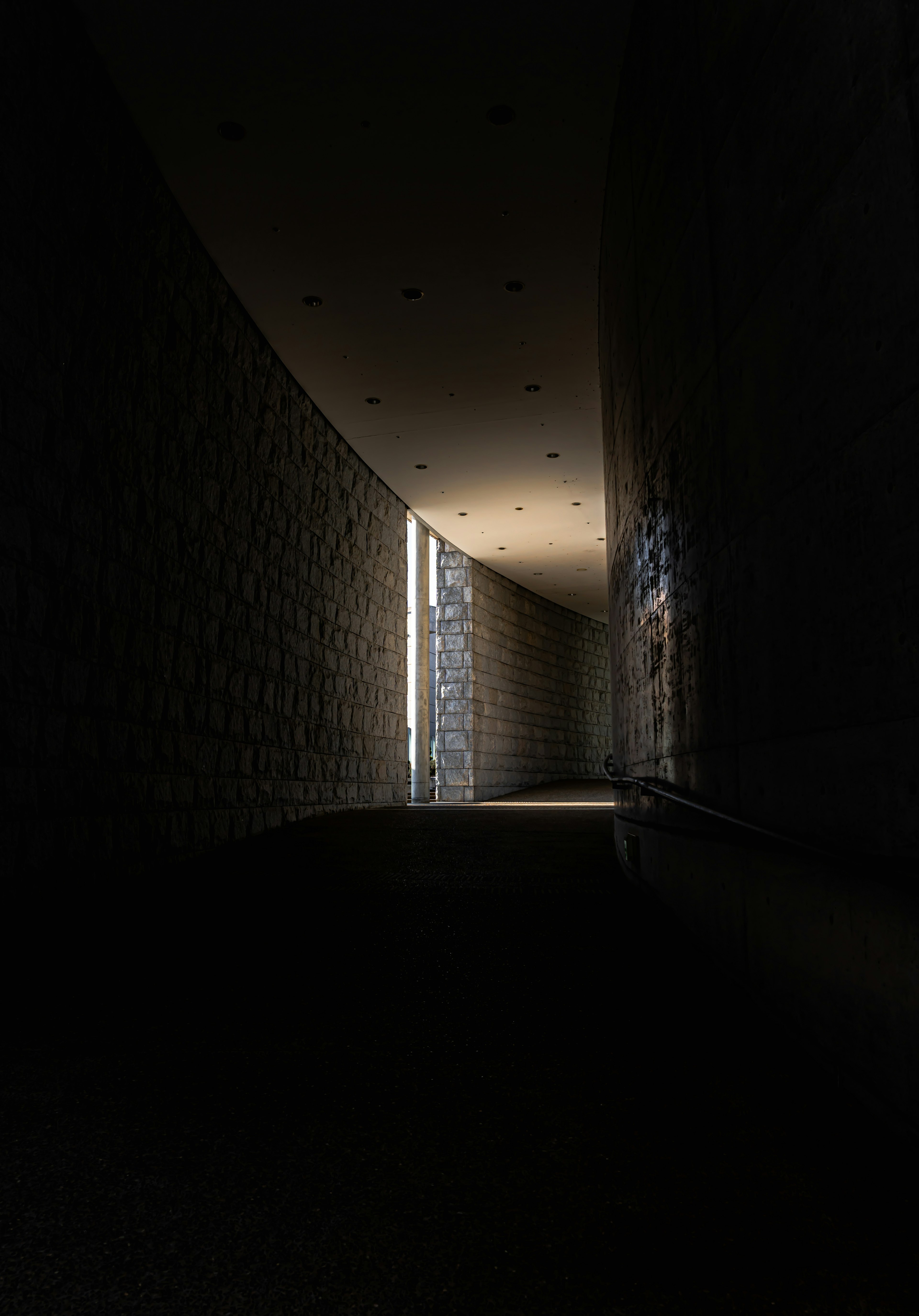 A scene with light streaming through a dark corridor