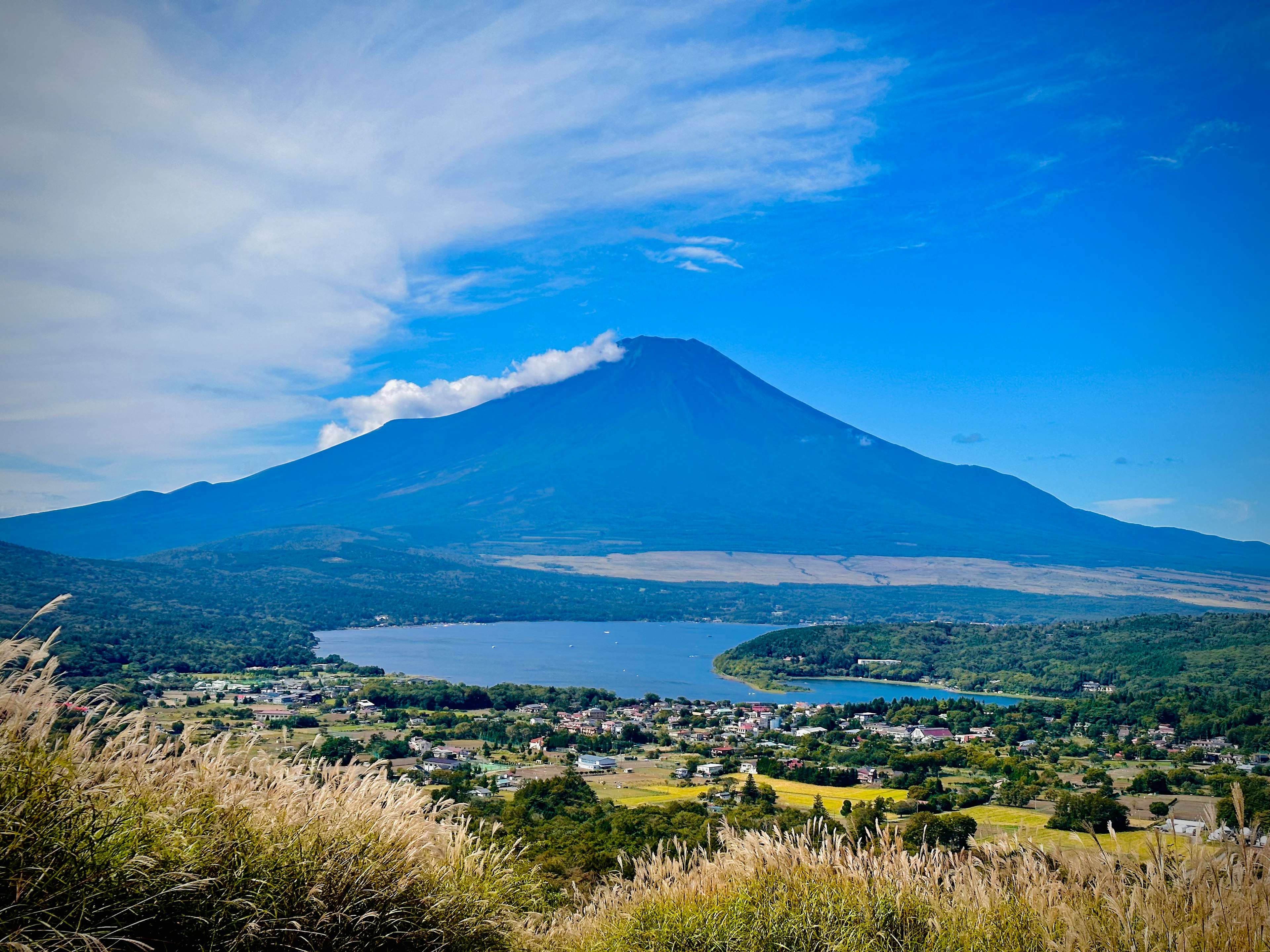 Scenic view of a mountain and lake under a clear blue sky