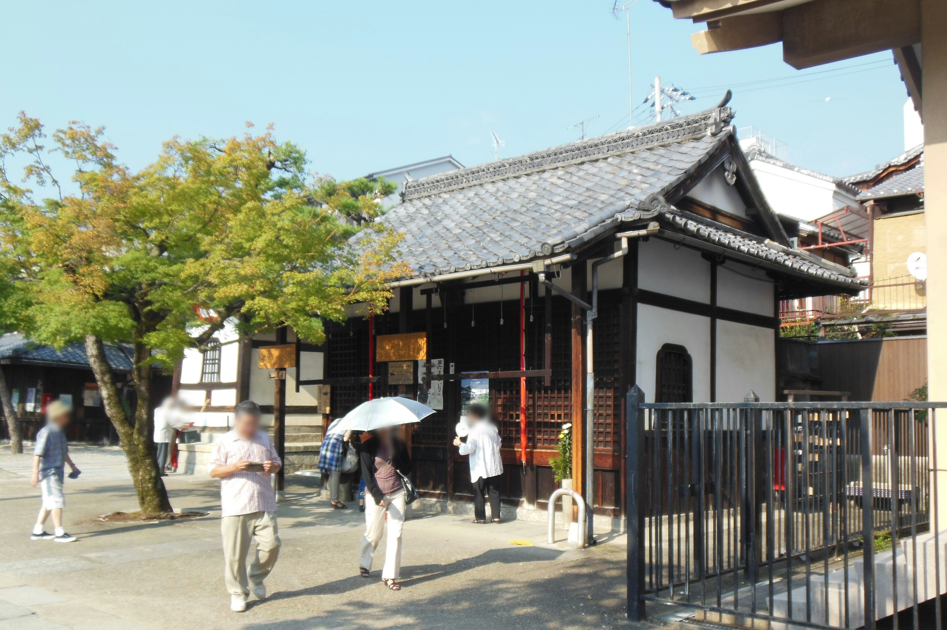 Scenic view with traditional Japanese building and people walking