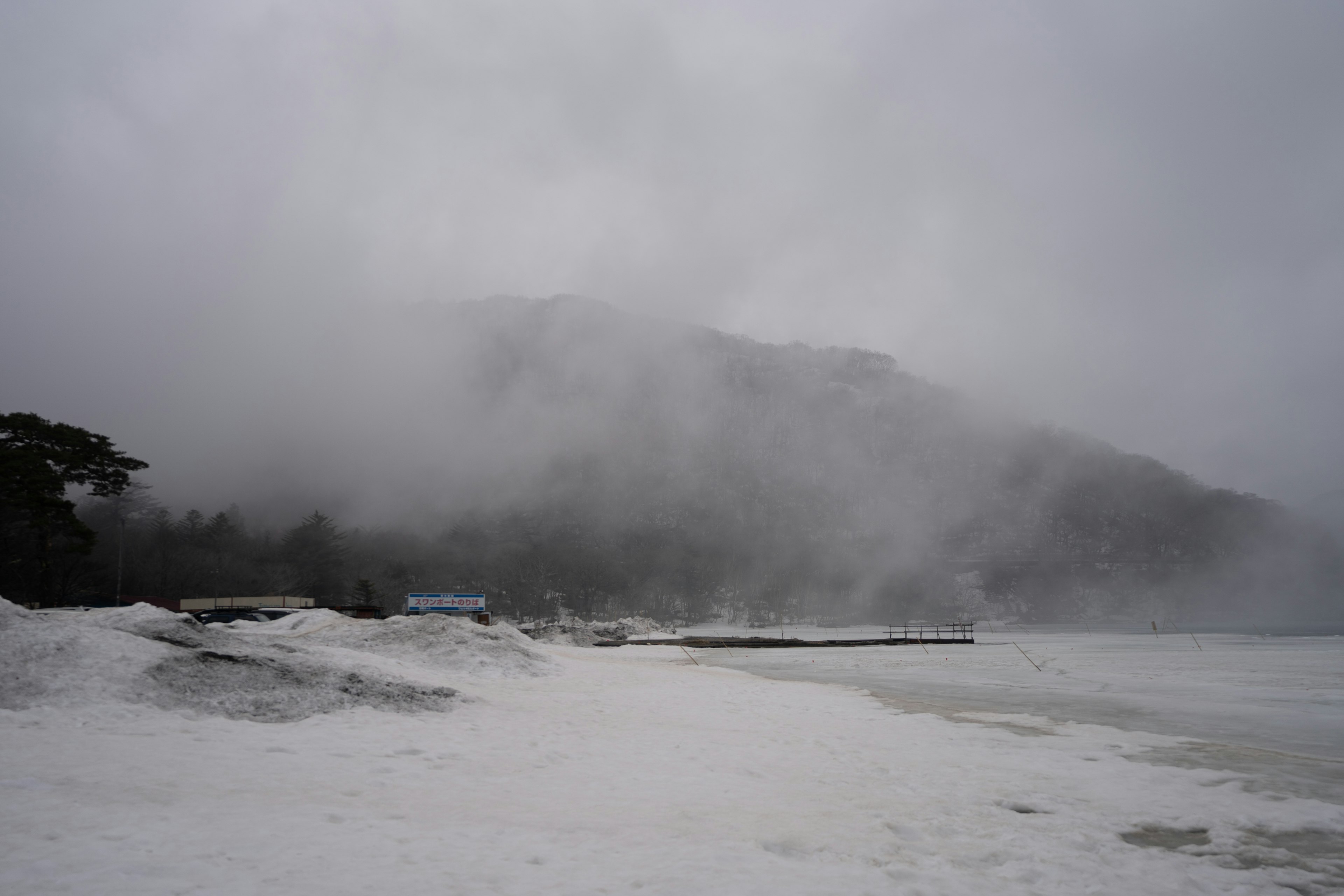 Foggy mountains and white sandy beach landscape