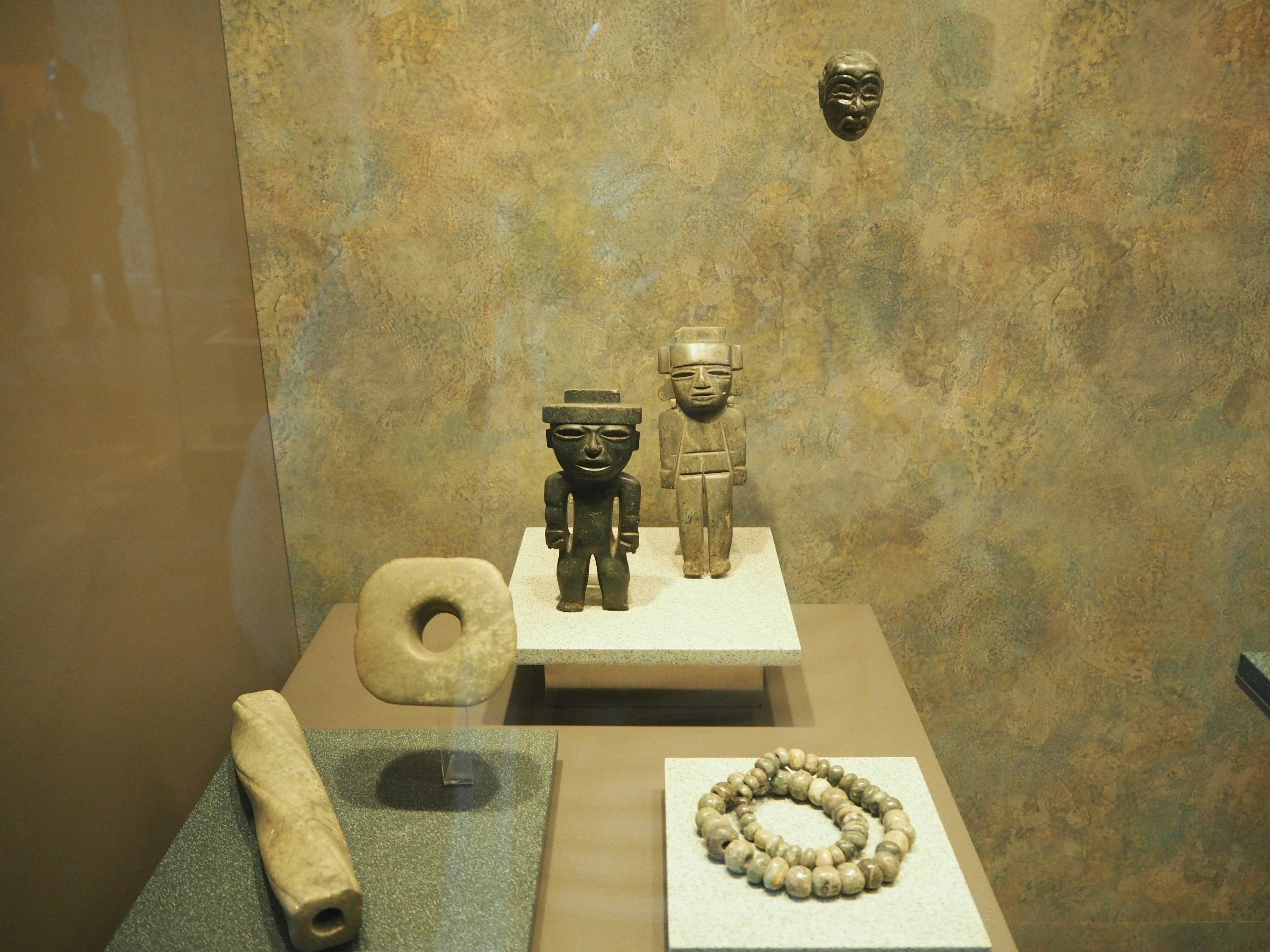 Room displaying ancient sculptures and decorative artifacts