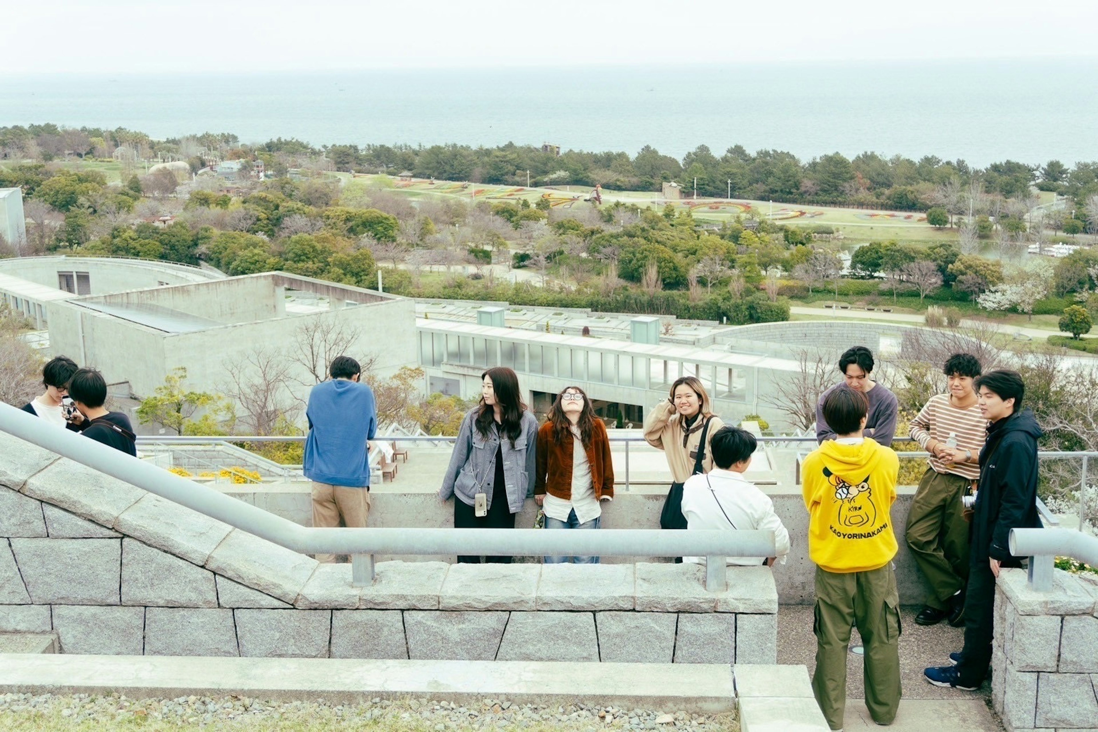 Group of young people gathered with ocean view in the background