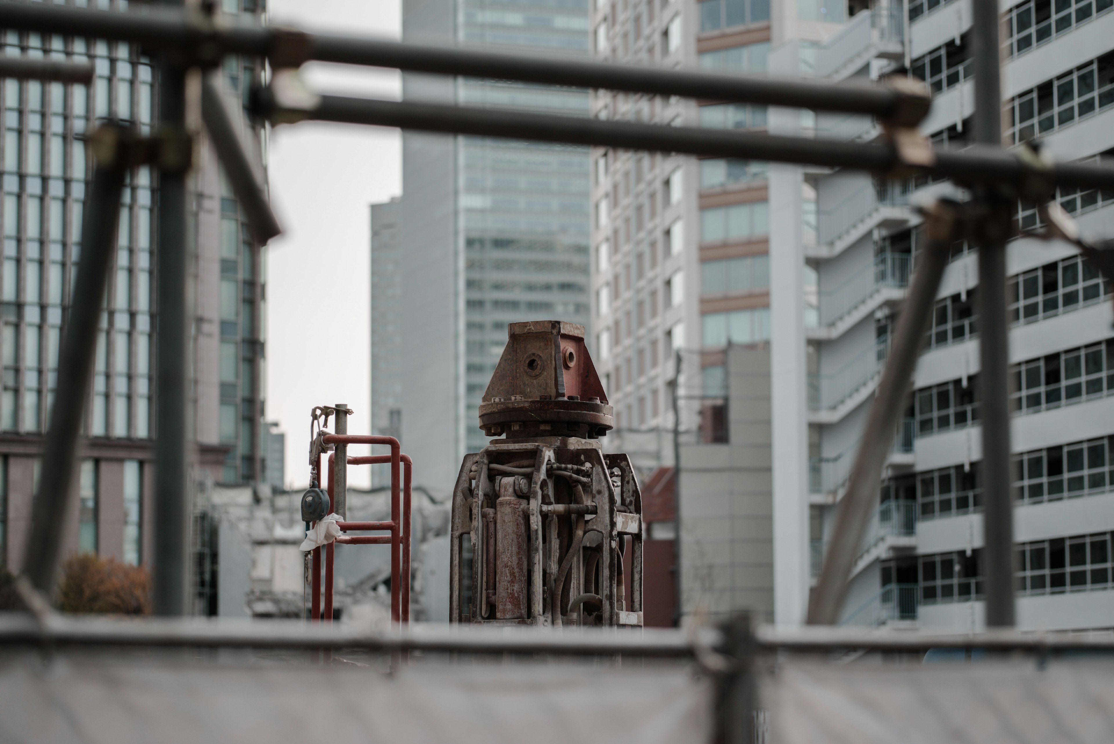 Close-up of construction machinery between buildings