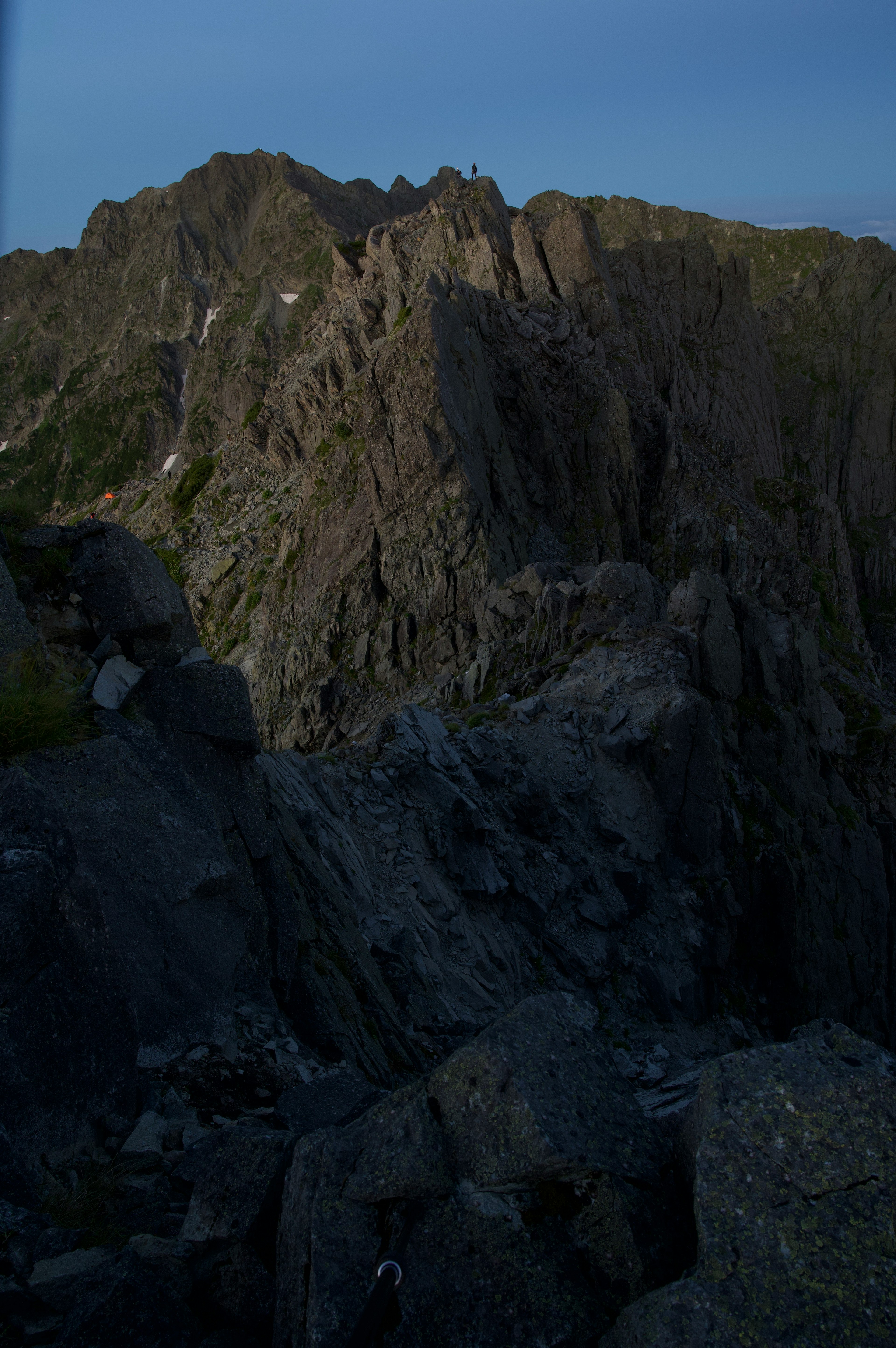 Rugged mountain landscape with rocky cliffs and shadows