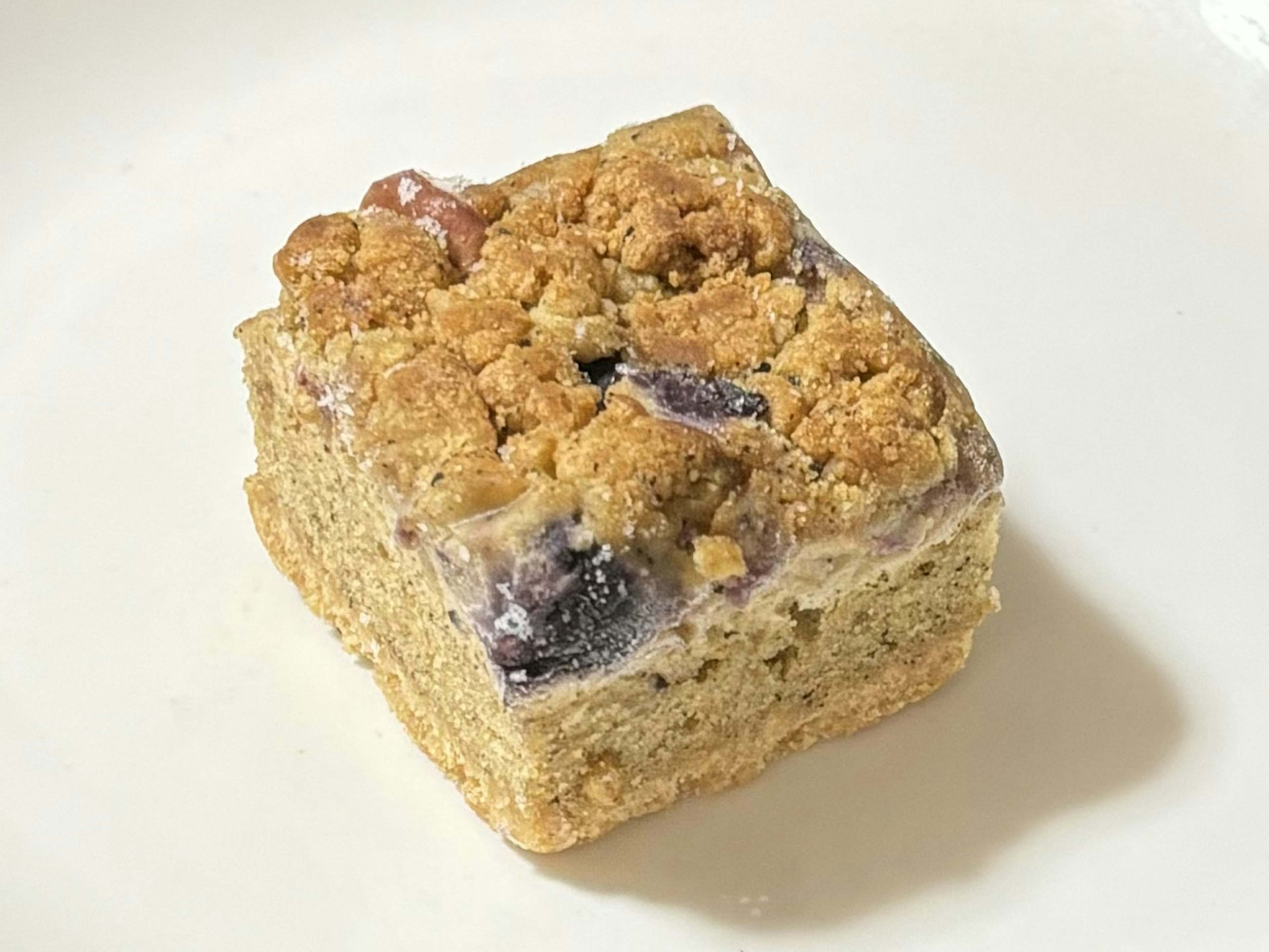 Square slice of baked dessert topped with crumble