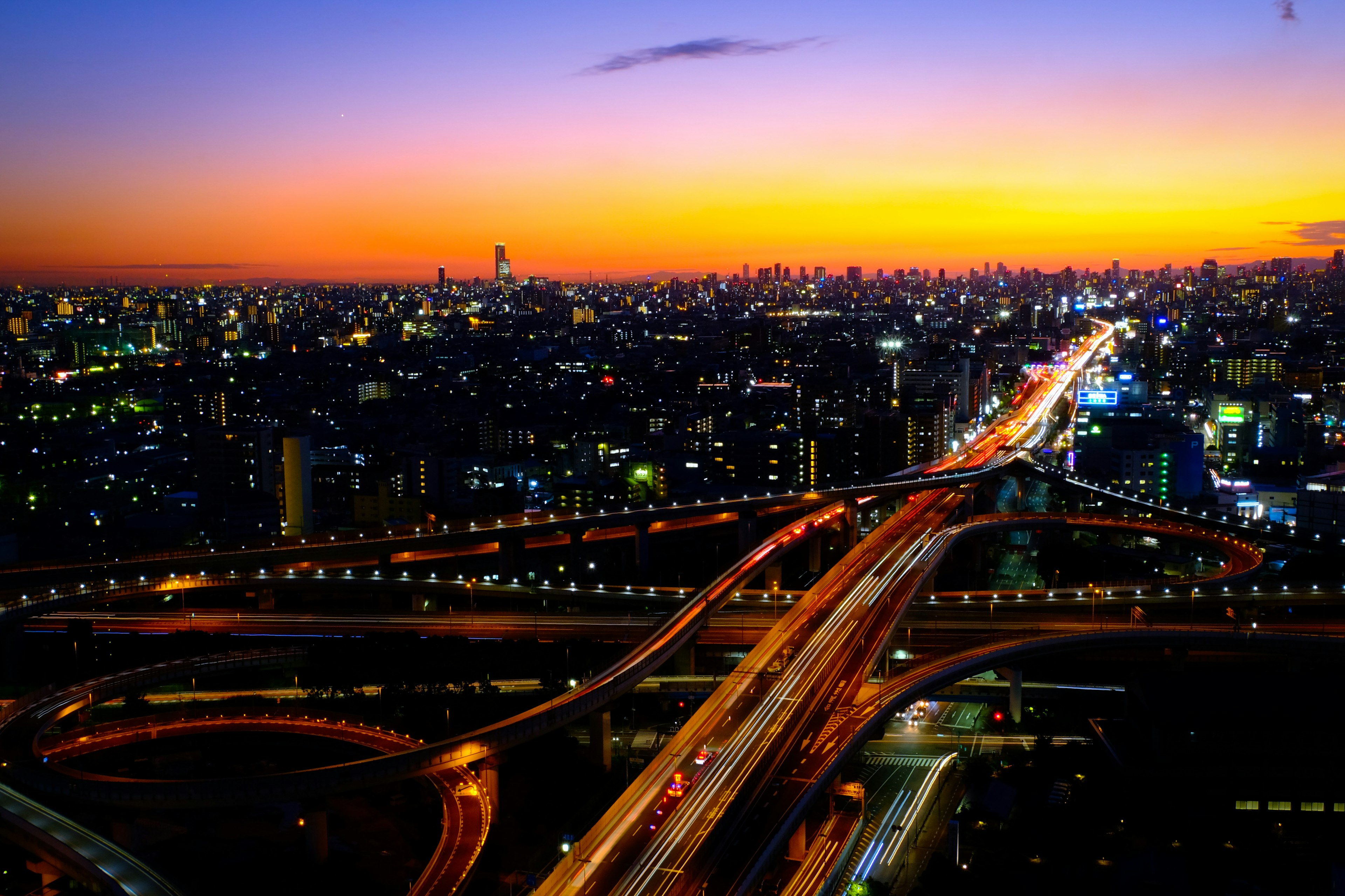 Tokyo cityscape at dusk featuring skyscrapers and intersecting highways