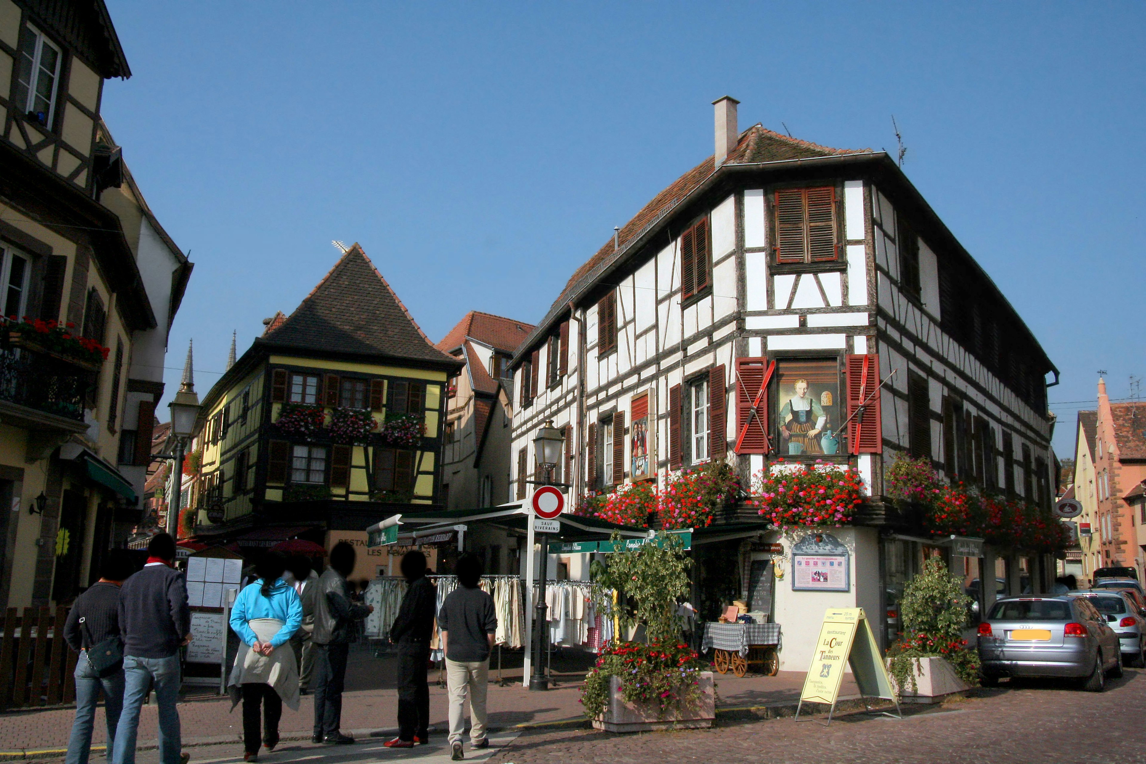 Traditional half-timbered houses in Alsace with tourists gathering