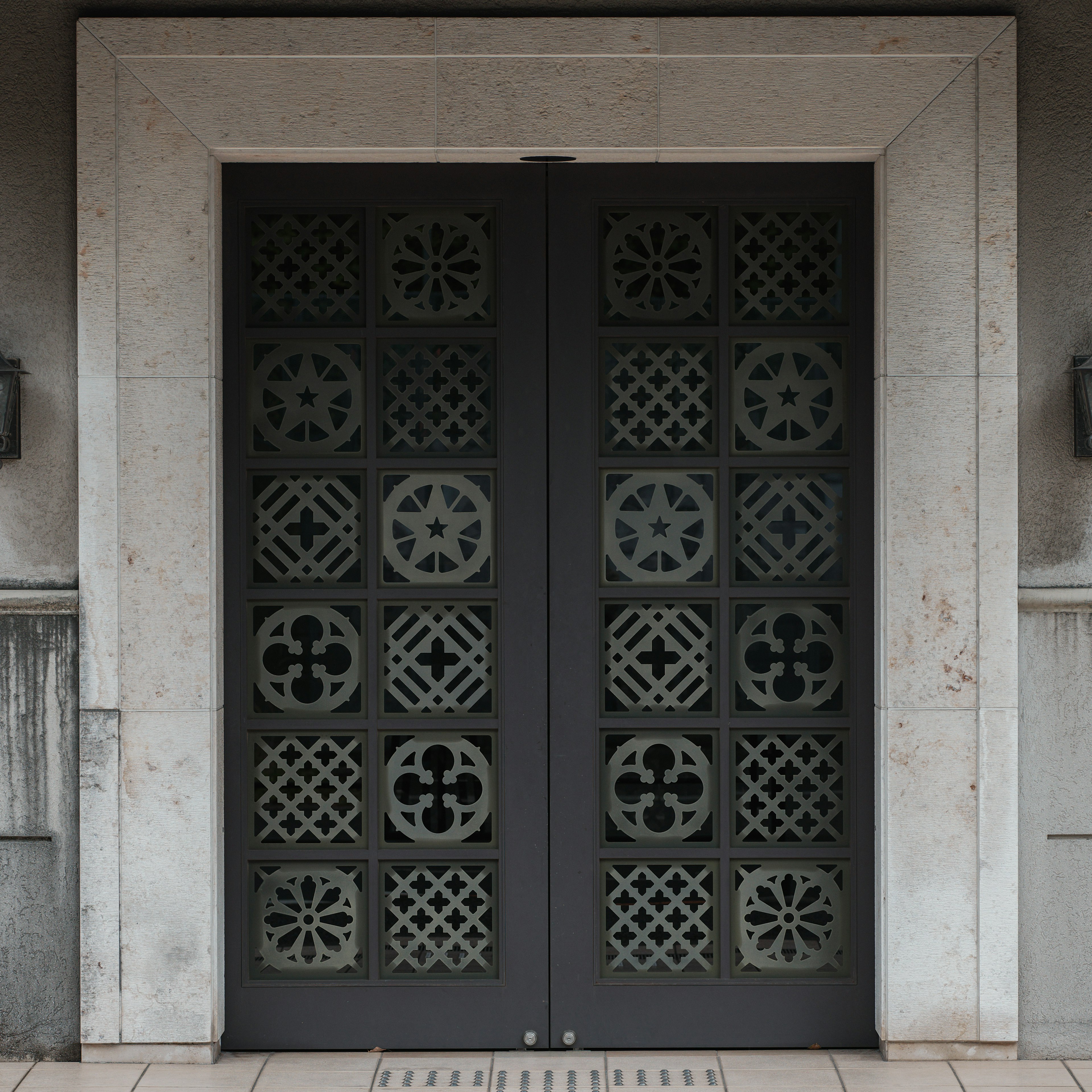 Decorative black door set in a stone frame