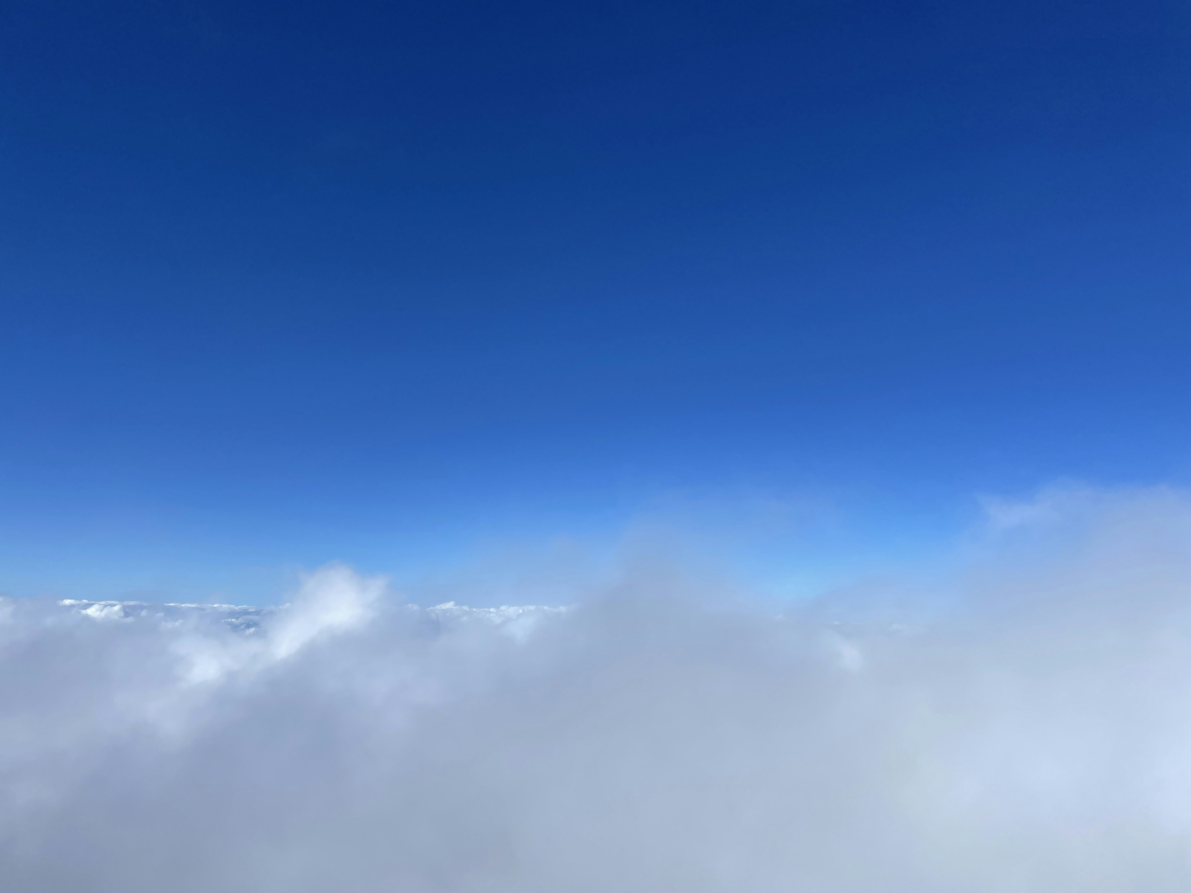 Expansive blue sky with white clouds