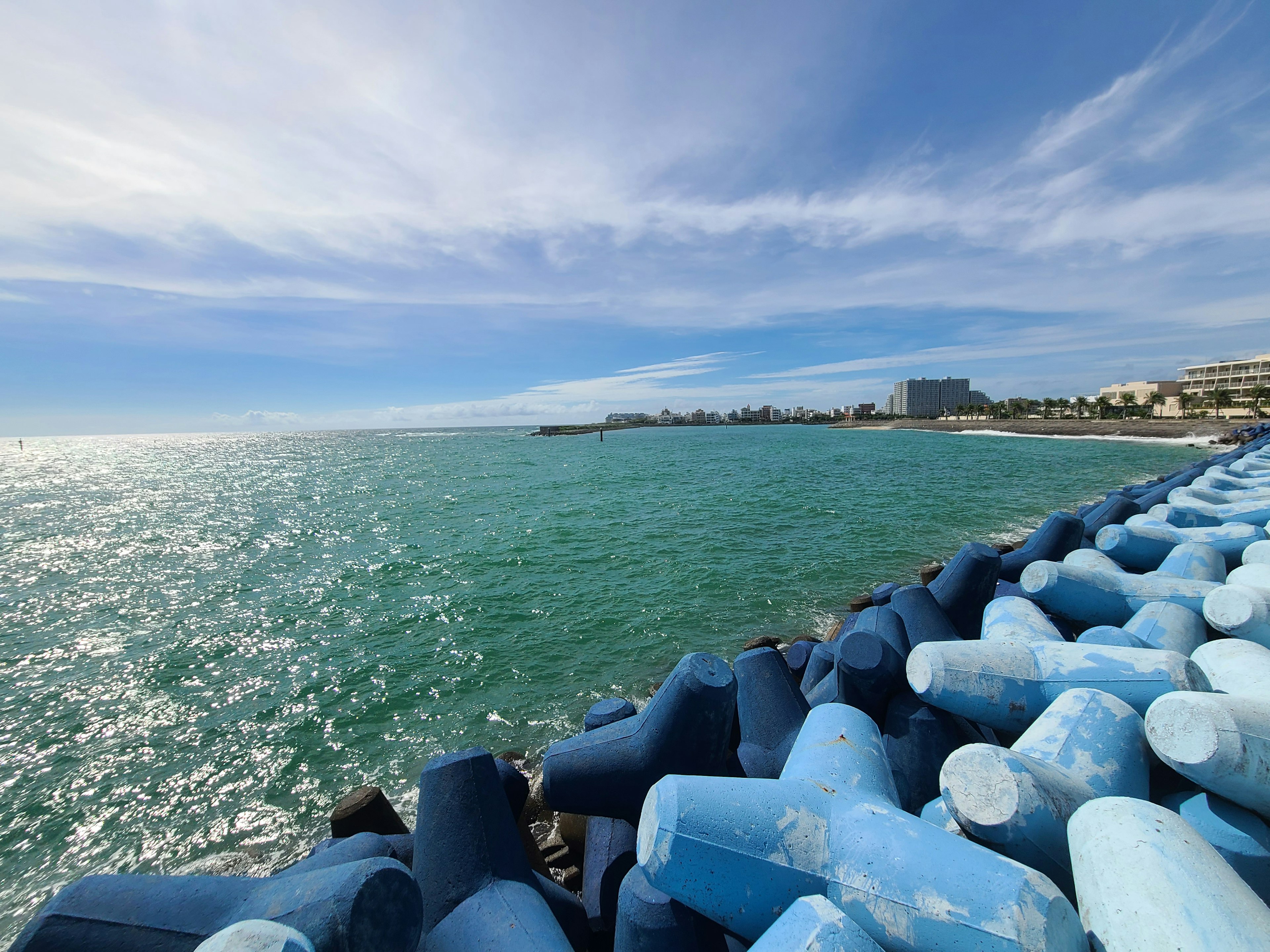 Blue breakwater and ocean view with a clear sky