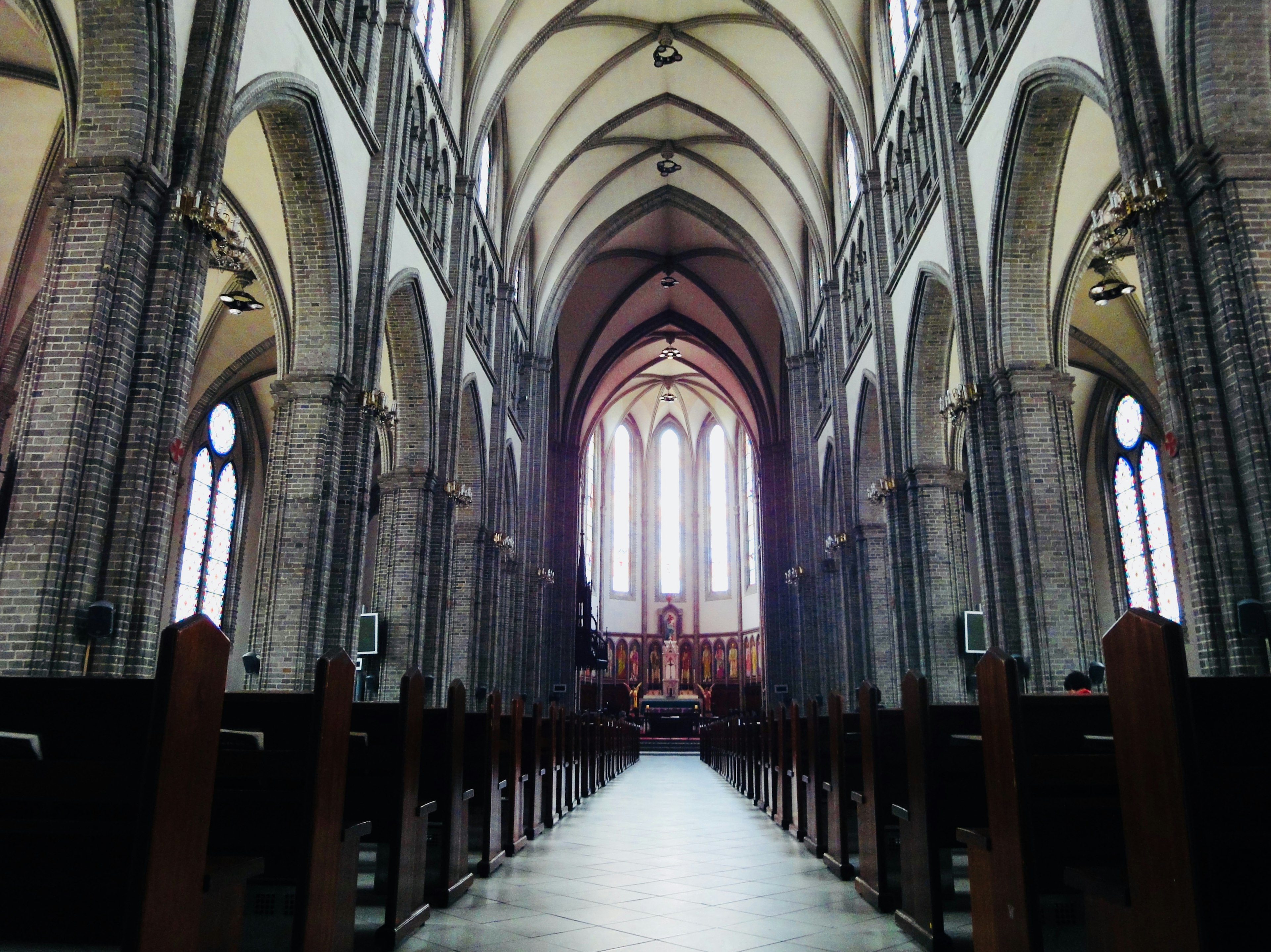 Interior of a cathedral featuring beautiful architecture and a long aisle with high ceilings