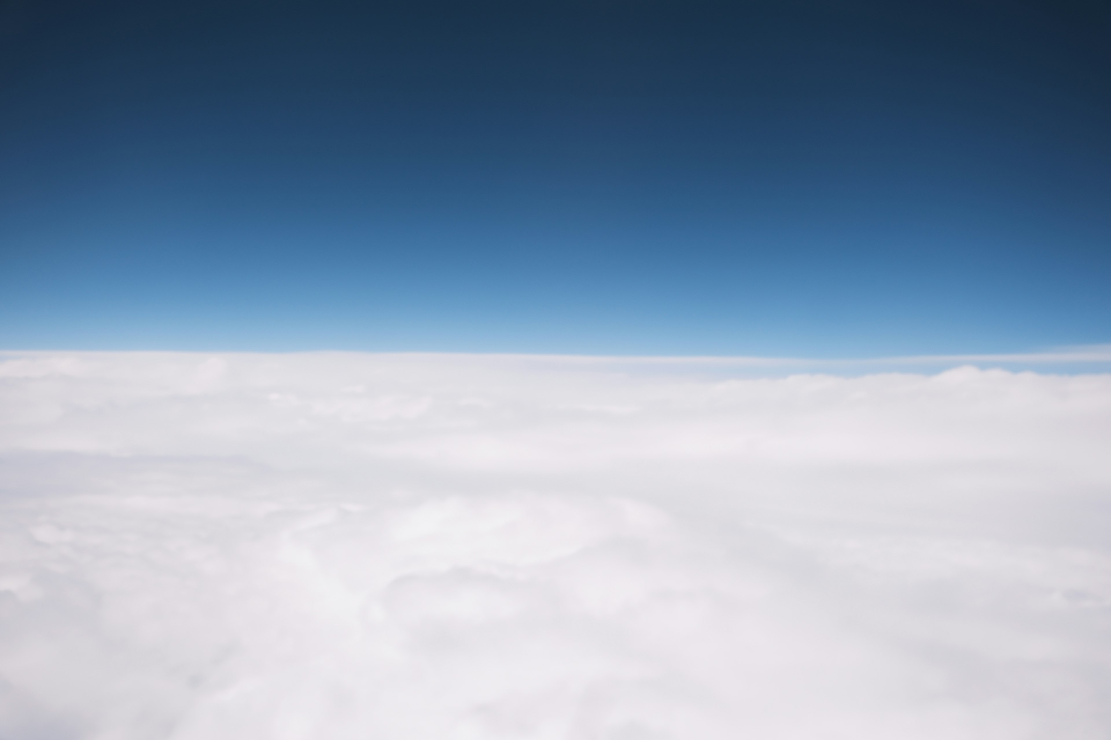 Vast blue sky above fluffy white clouds